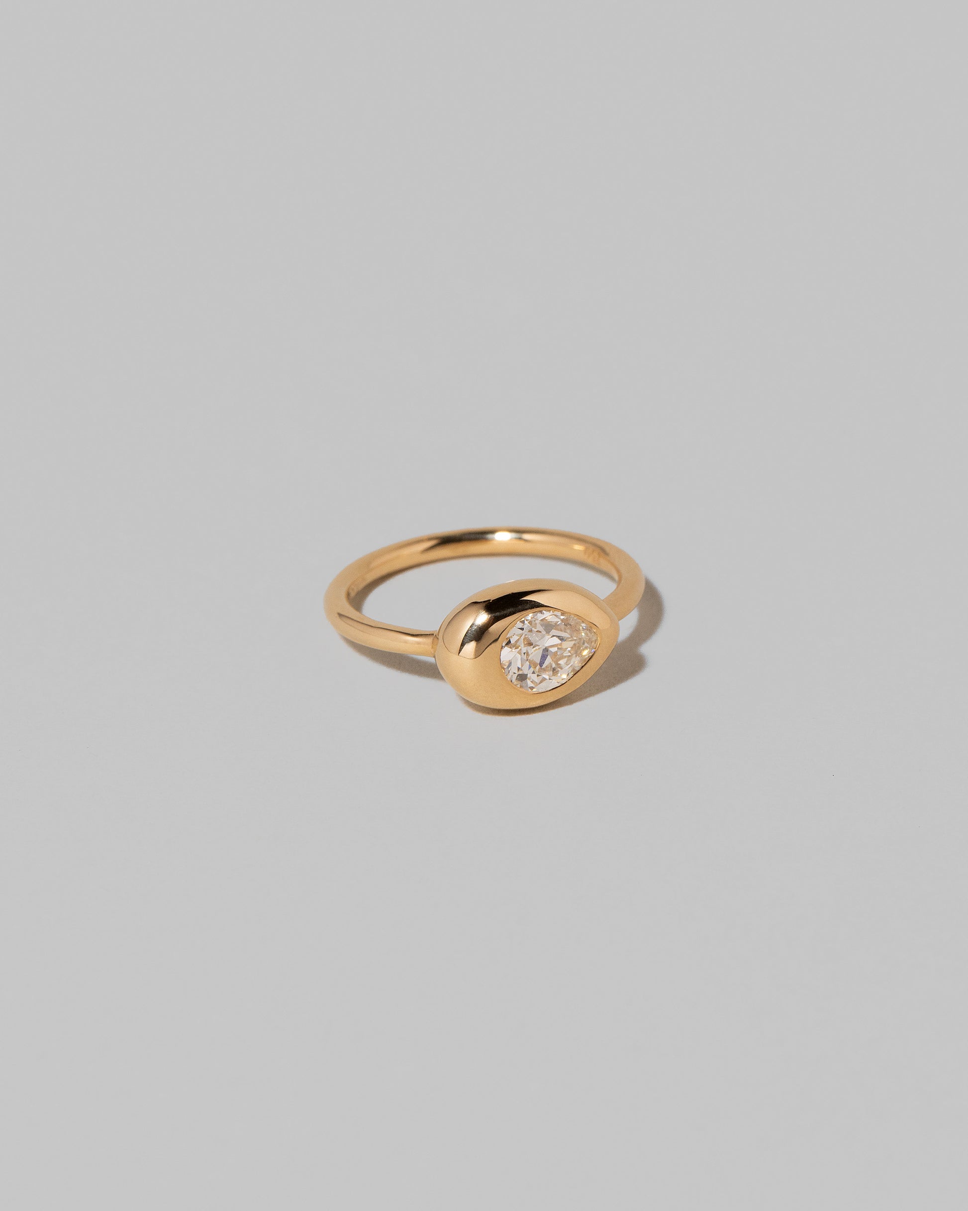 View from the side of the Diamond Align Ring on light color background.