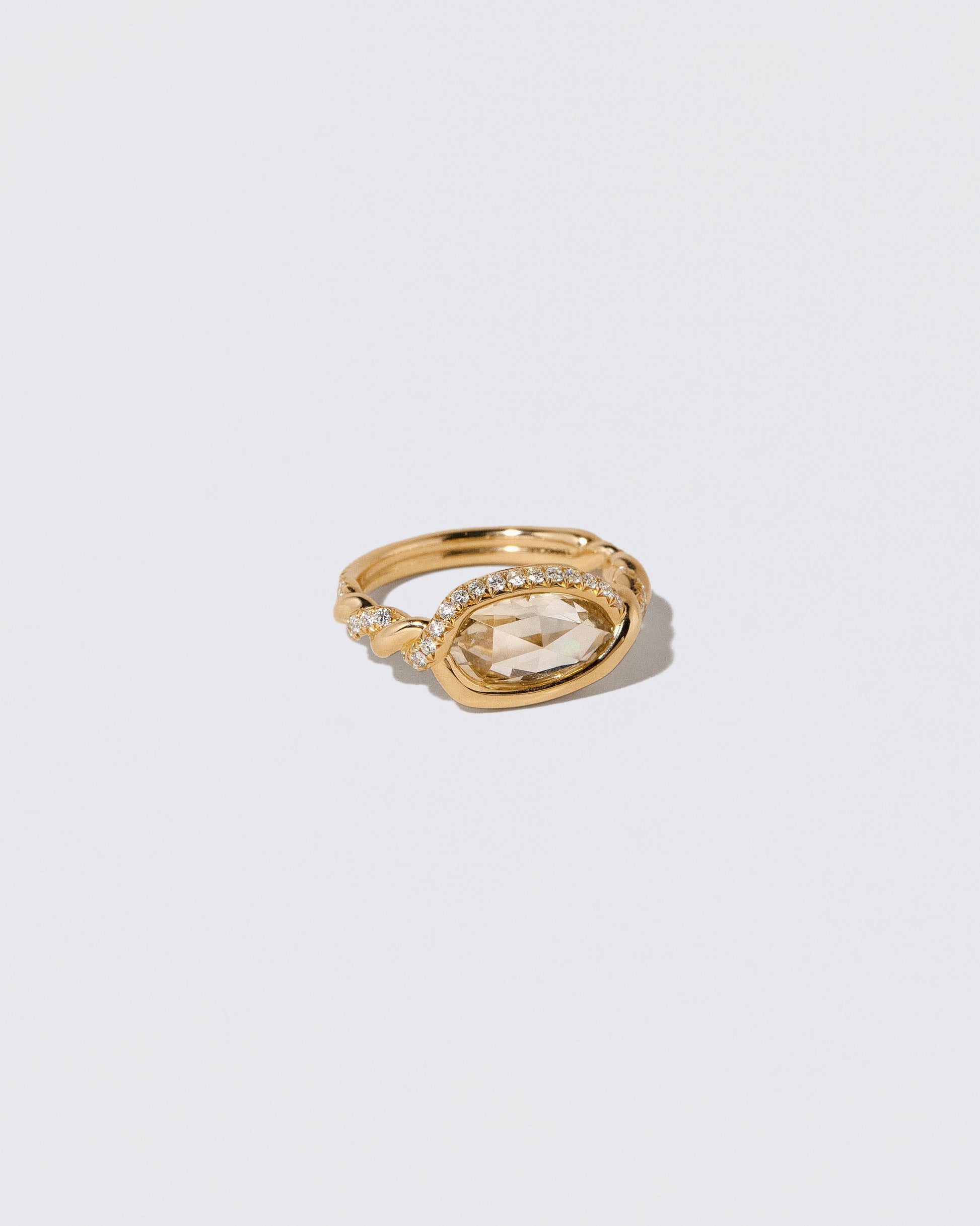 View from the side of the Encircle Ring on light color background.