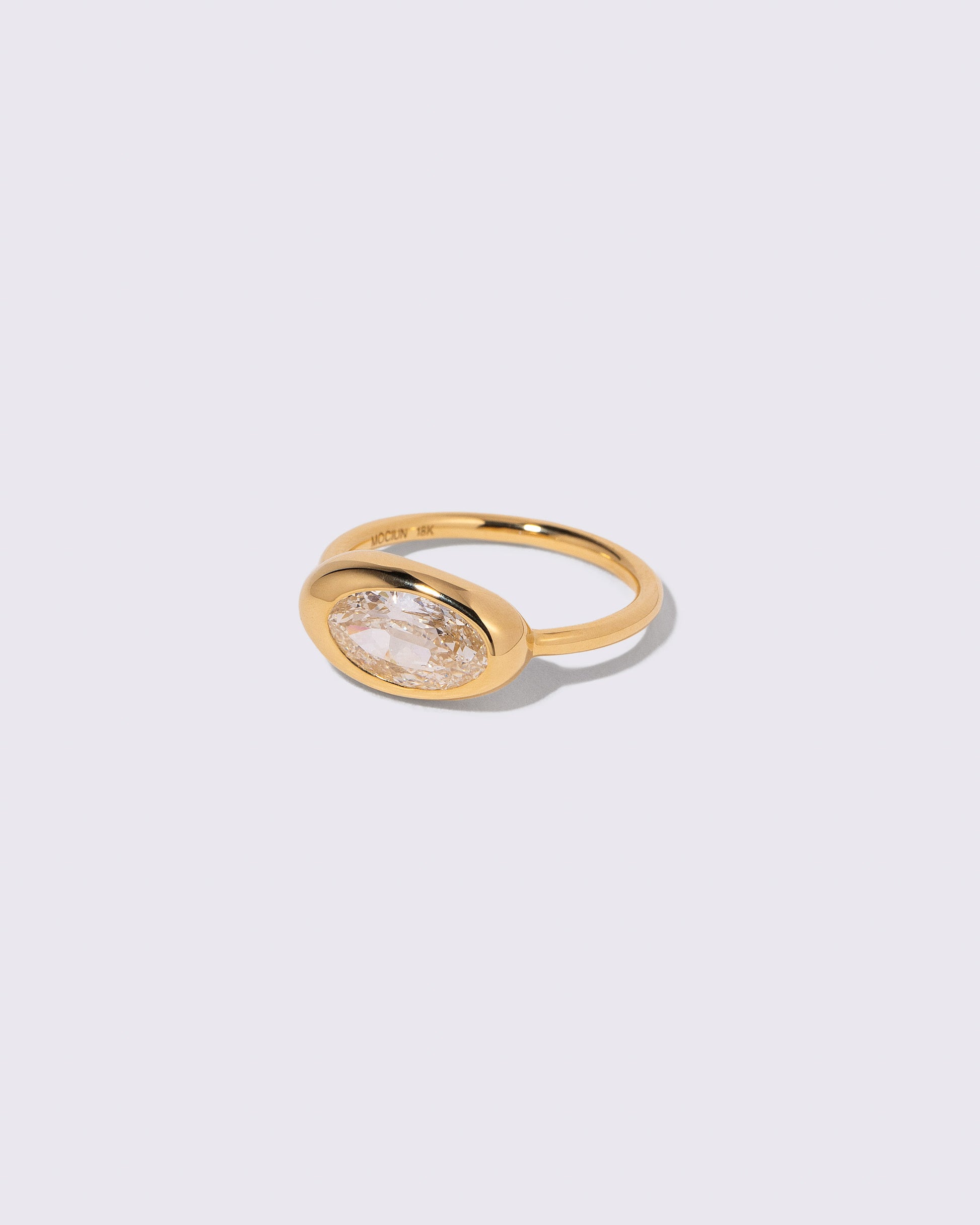 View from the side of the Moval Diamond Equalize Ring on light color background.