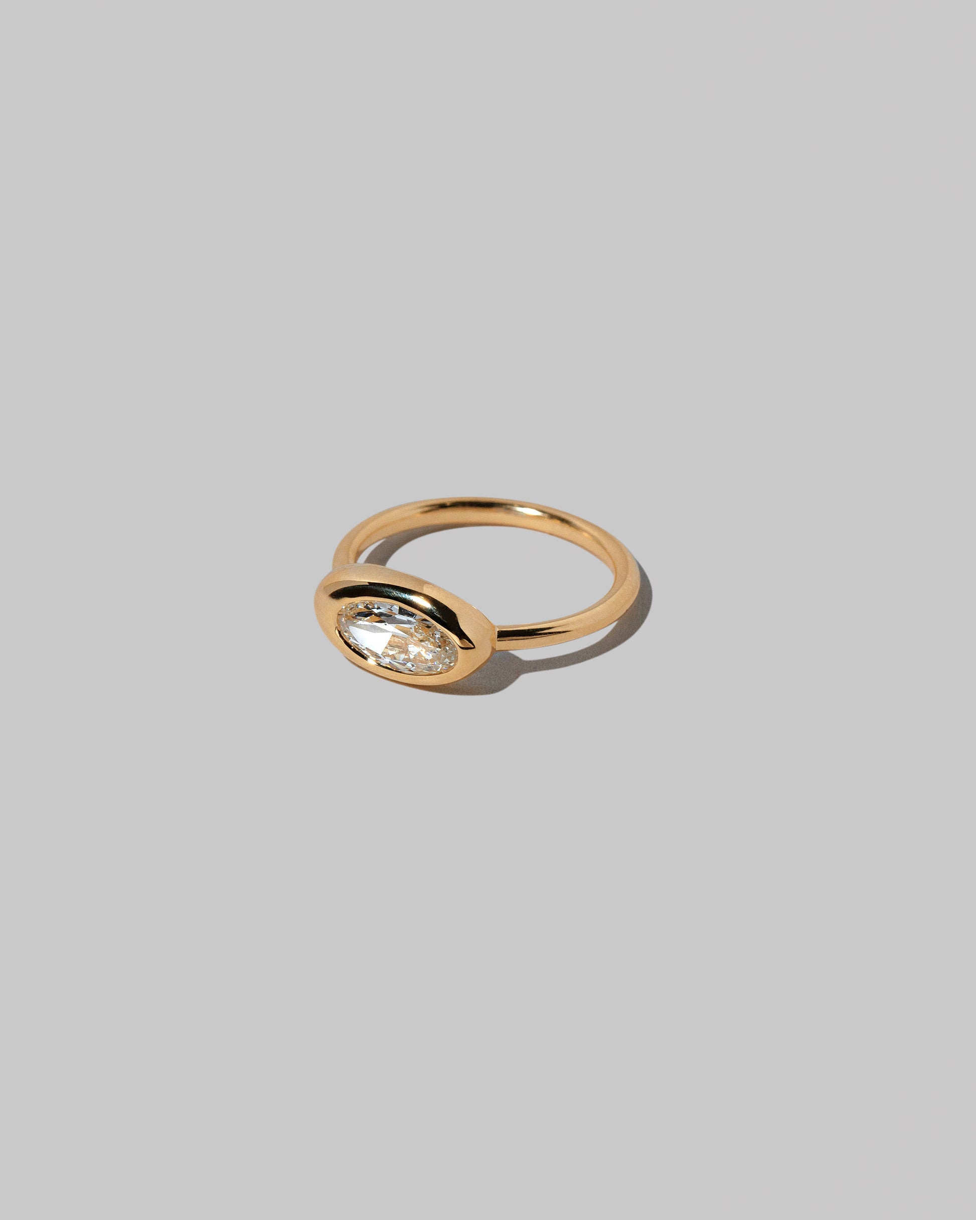 View from the side of the Moval White Diamond Equalize Ring on light color background.