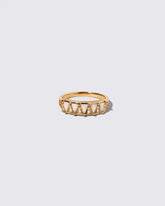 Gold White Opal Five Triangle Ring on light color background.