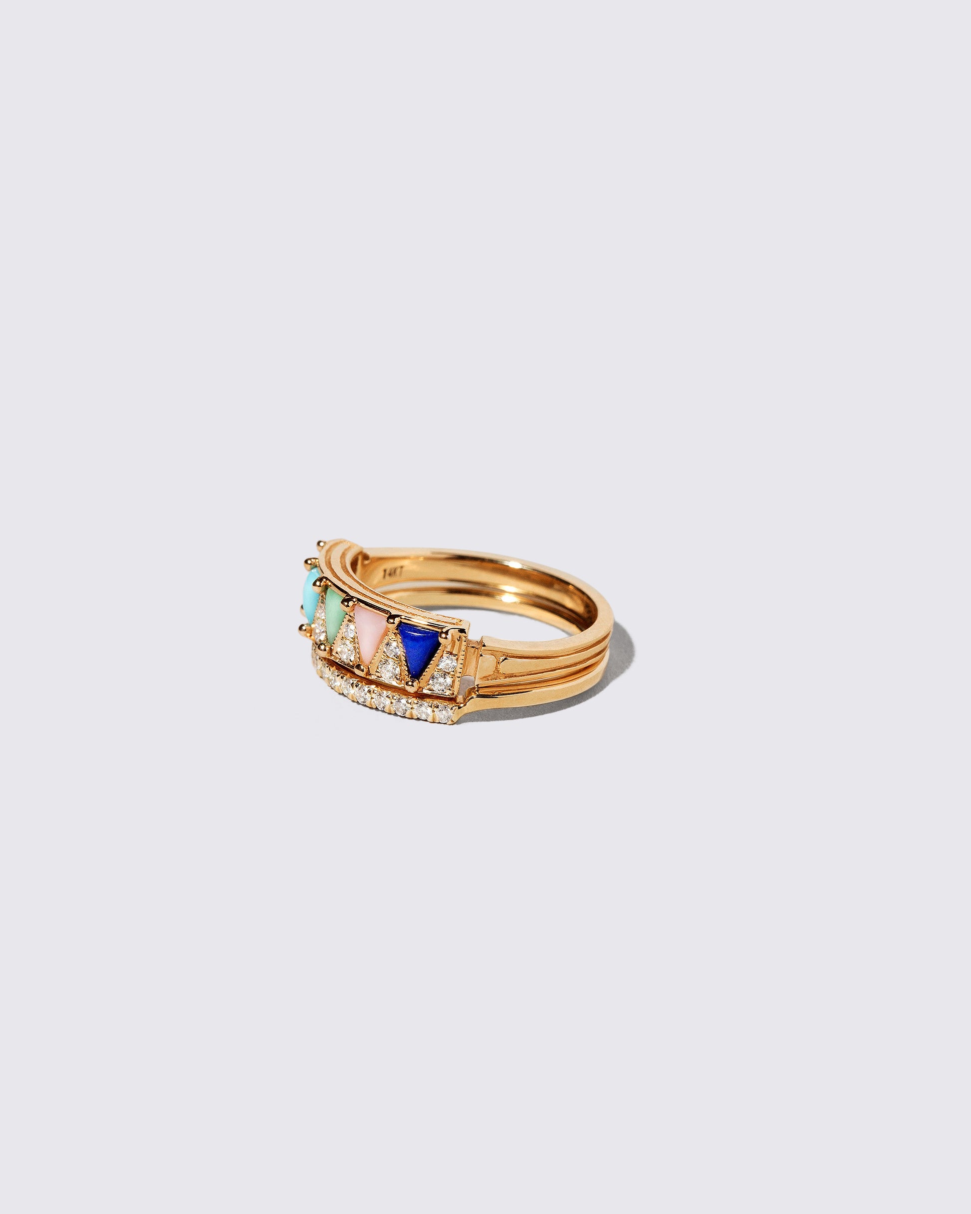View from the side of the Gold Notched Band and Gold Mega Five Triangle Ring on light color background.