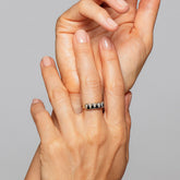 product_details::Gold Black Spinel Five Triangle Ring on model.