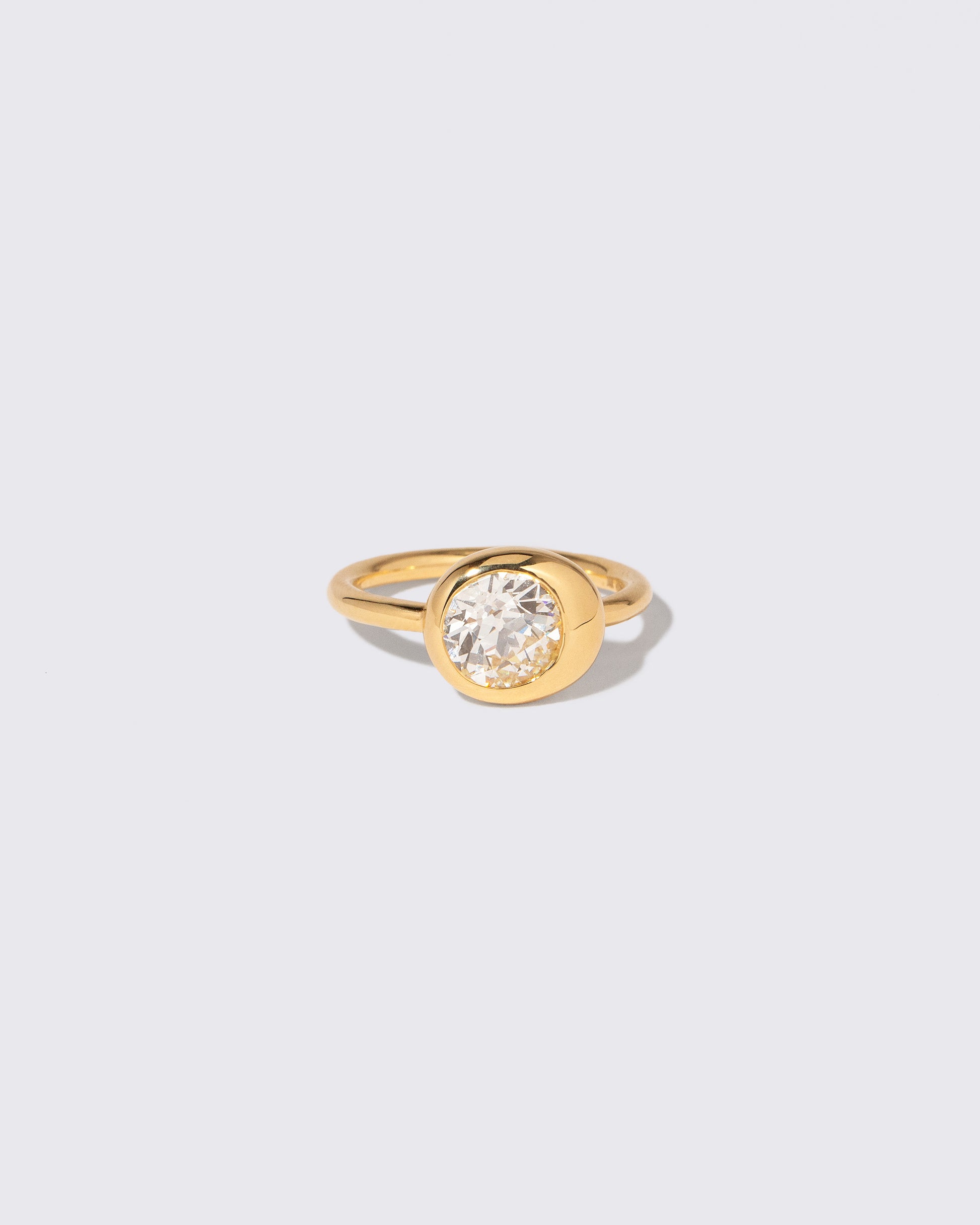 View from the side of the Diamond Grand Level Ring on light color background.