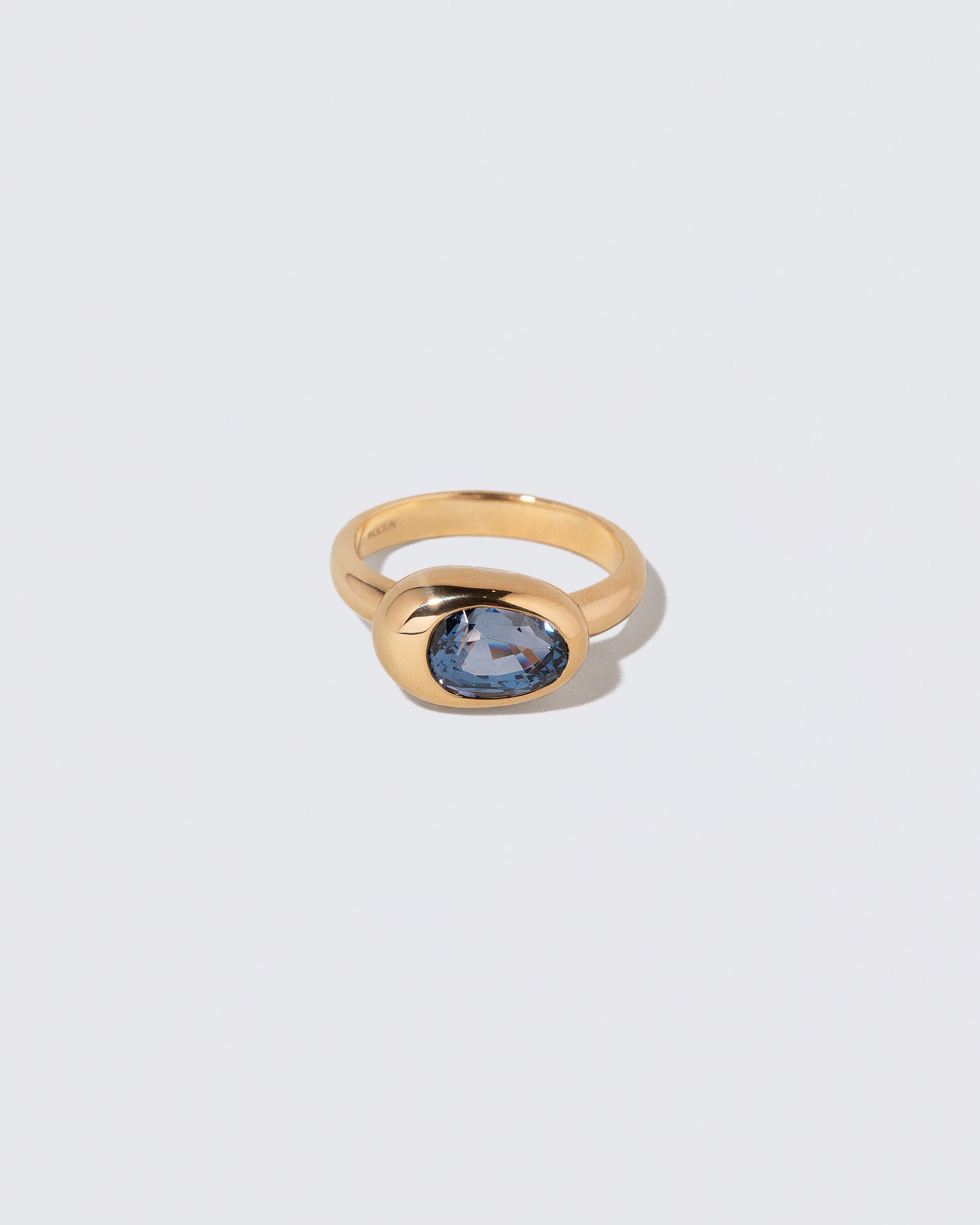 Spinel Grand Align Ring on light color background.