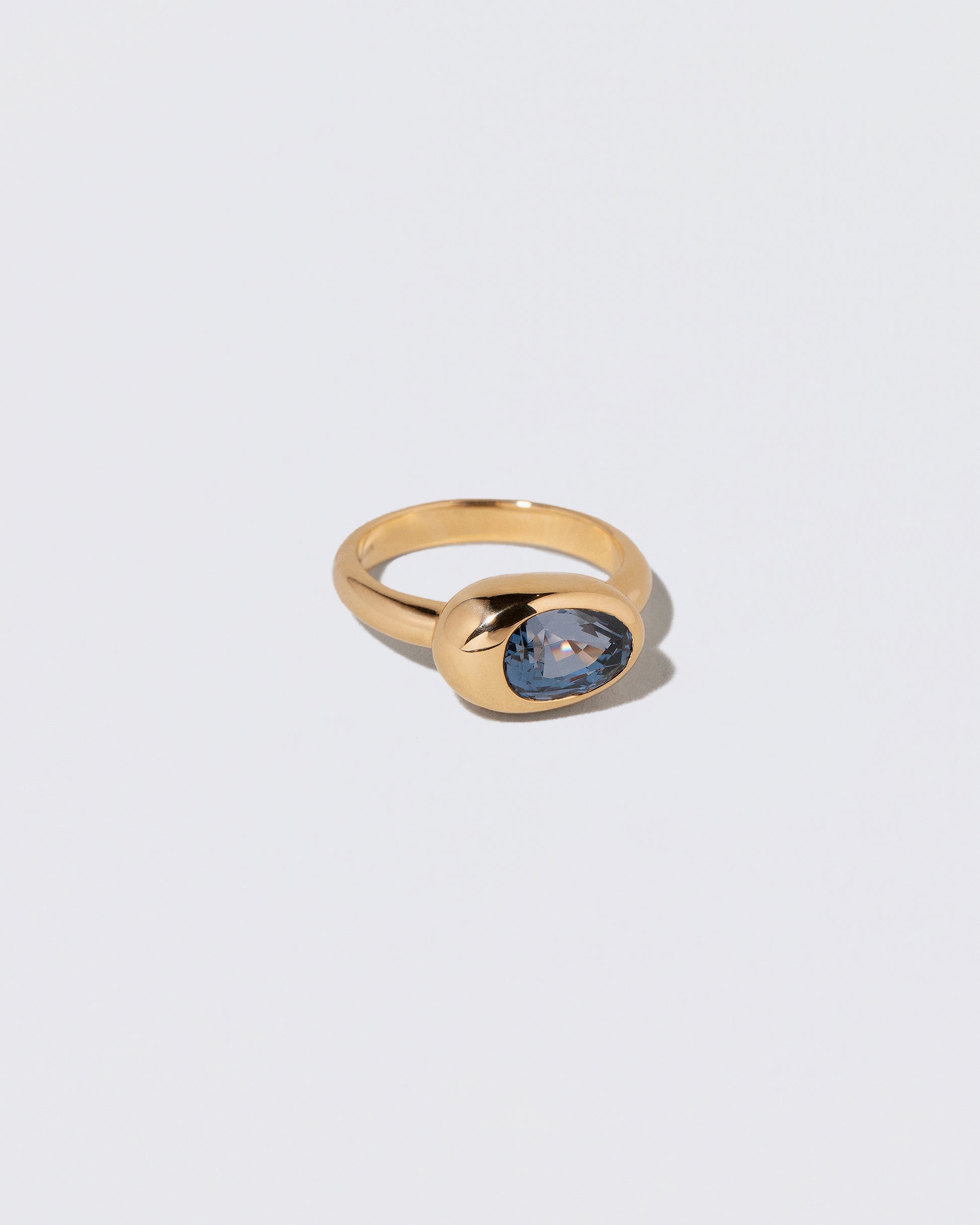 View from the side of the Spinel Grand Align Ring on light color background.