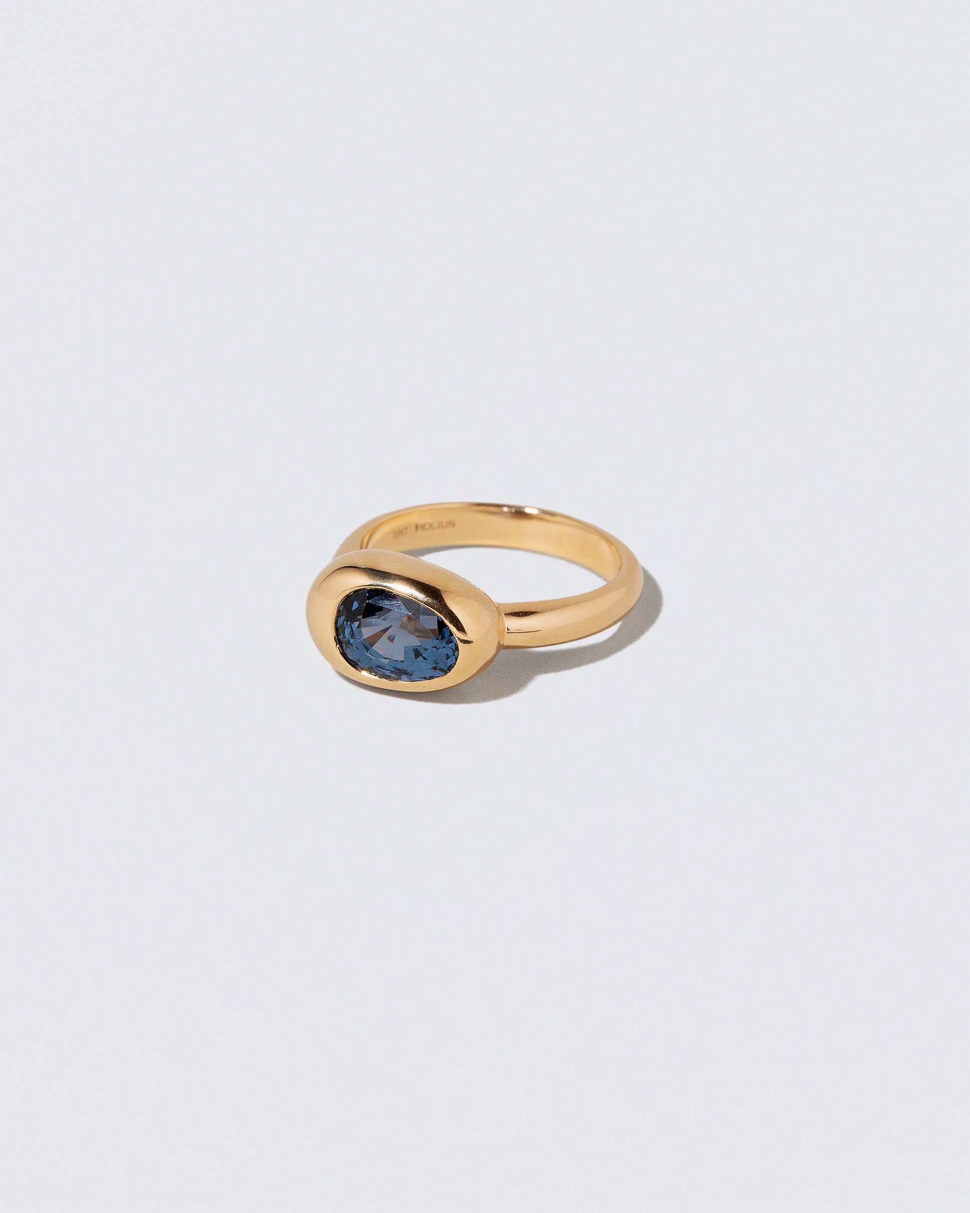 View from the side of the Spinel Grand Align Ring on light color background.