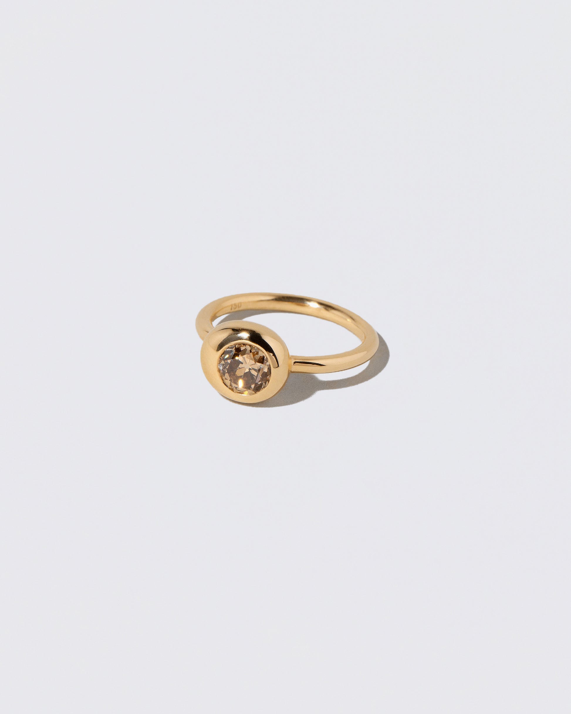 View from the side of the Champagne Diamond Grand Level Ring on light color background.