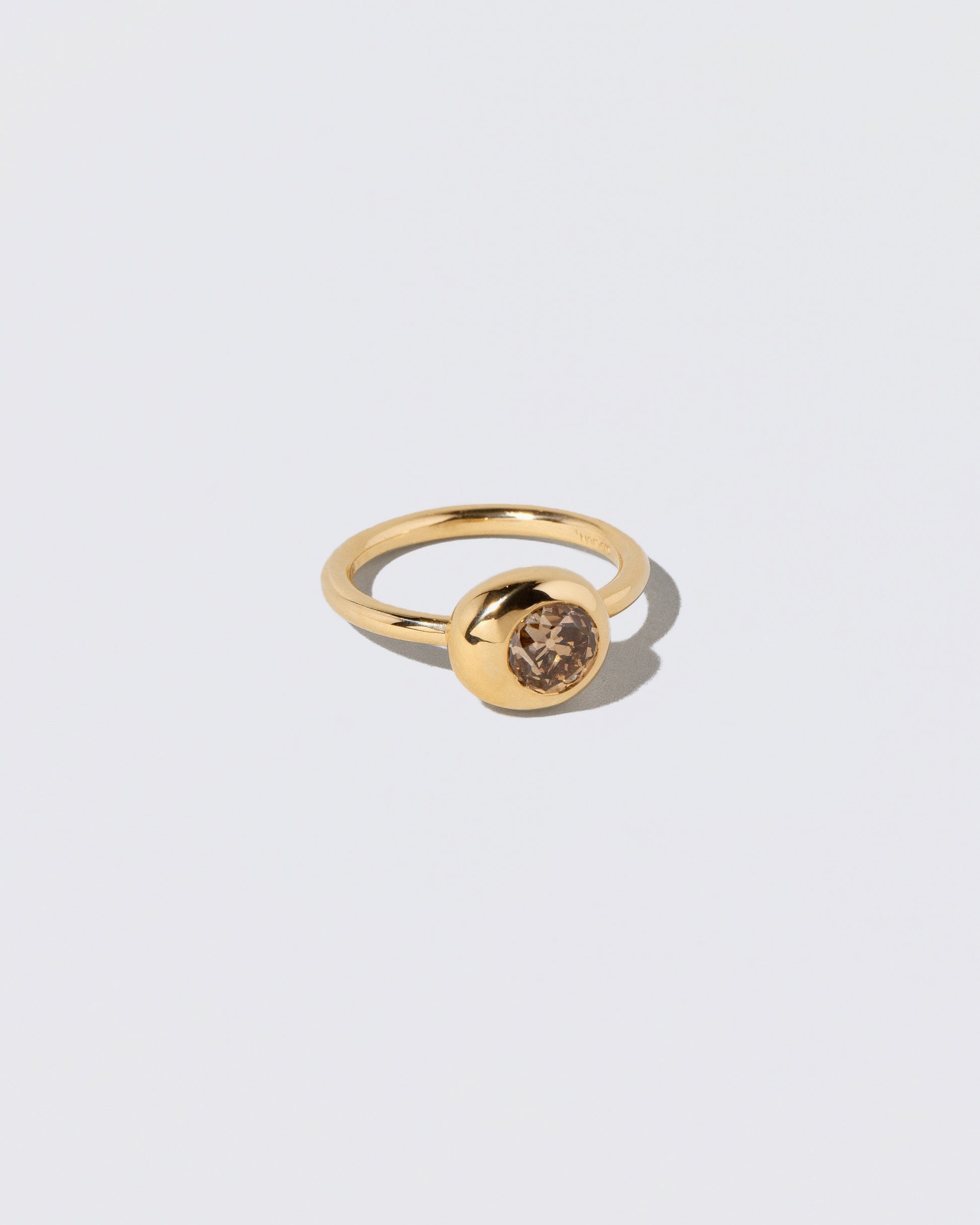 View from the side of the Champagne Diamond Grand Level Ring on light color background.