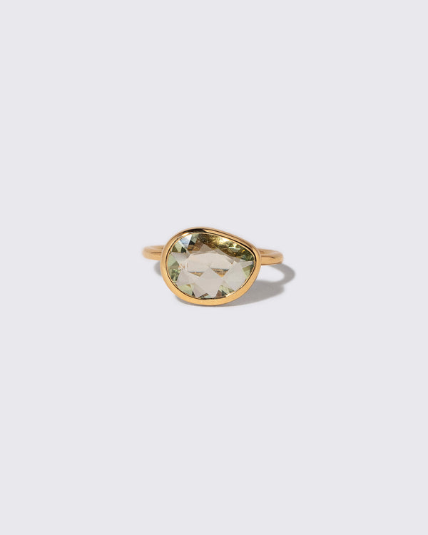 Green Sapphire Gusher Ring on light color background.