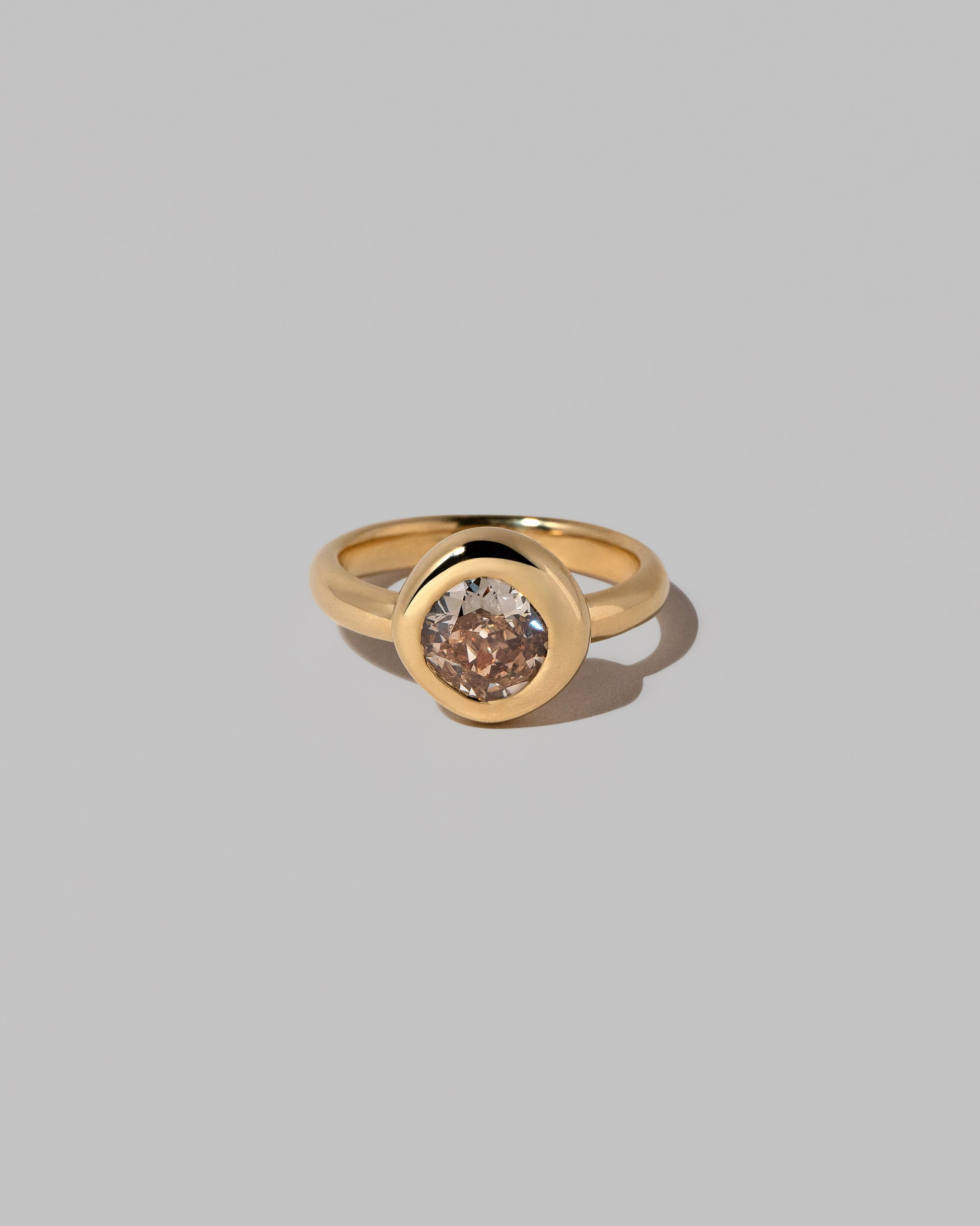 Brown Diamond Poise Ring on light color background.
