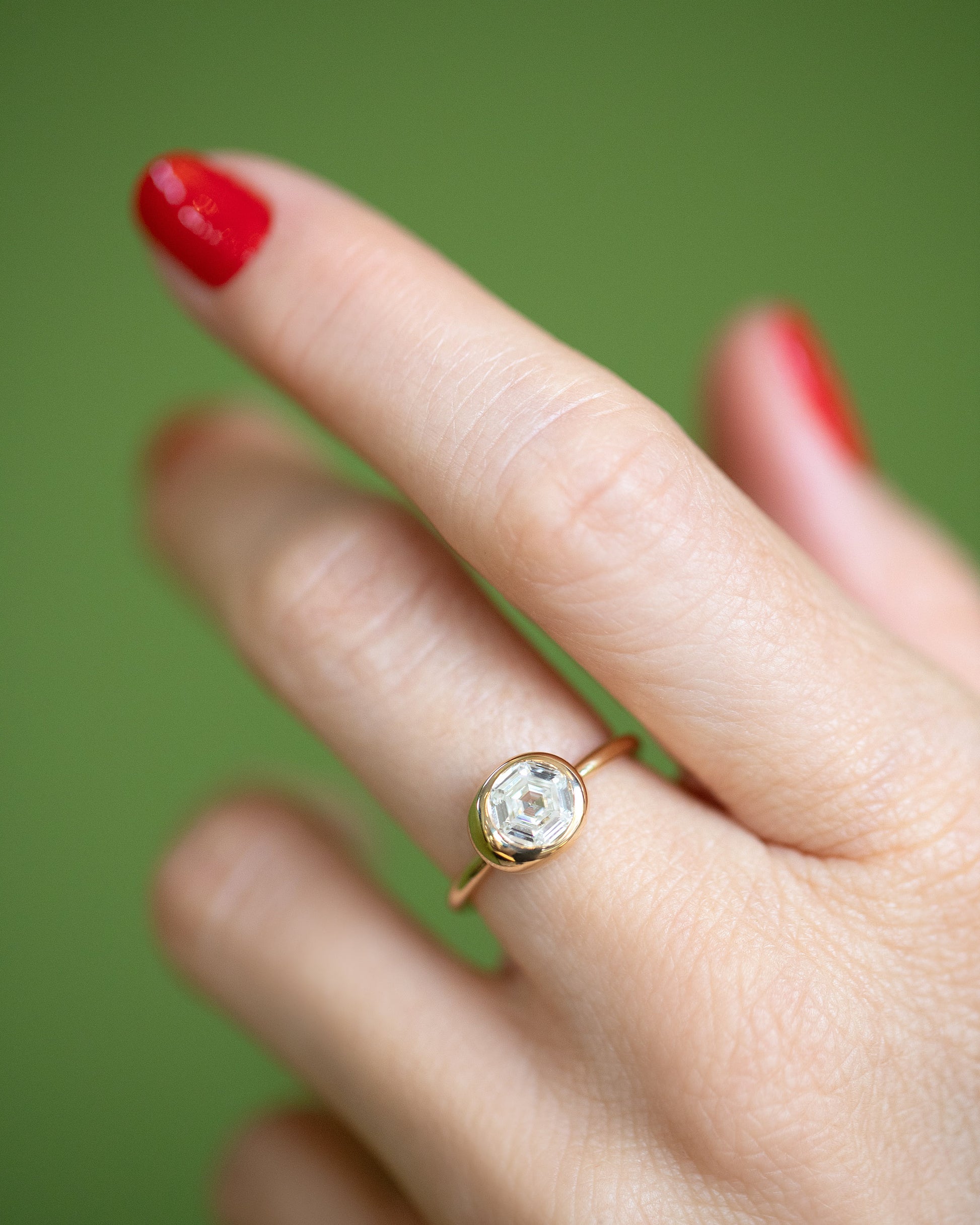 Closeup details of the Step Cut Diamond Grand Level Ring on model.