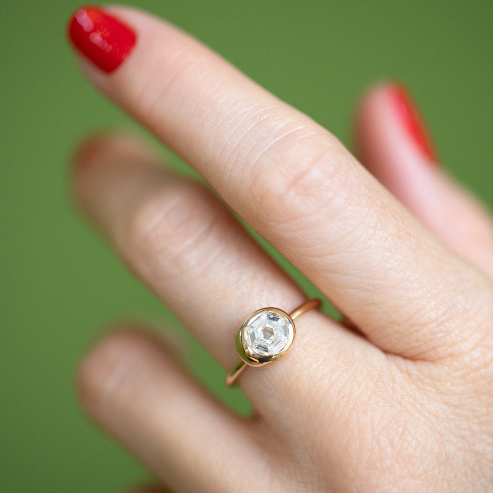 product_details::Step Cut Diamond Grand Level Ring on model.