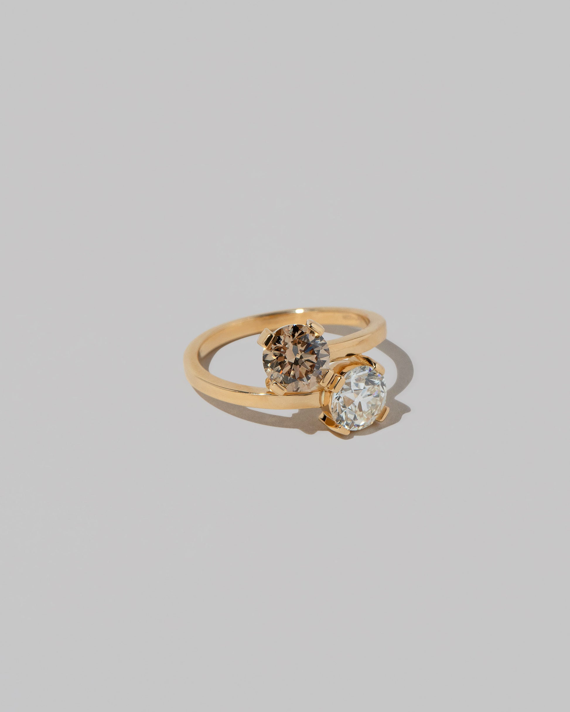 View from the side of a past version of the Champagne & White Diamond Union Ring on light color background.