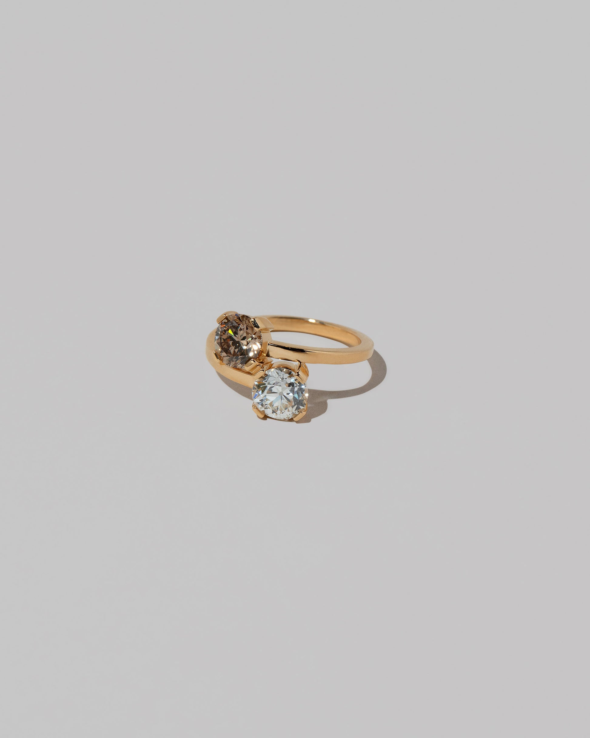 View from the side of a past version of the Champagne & White Diamond Union Ring on light color background.