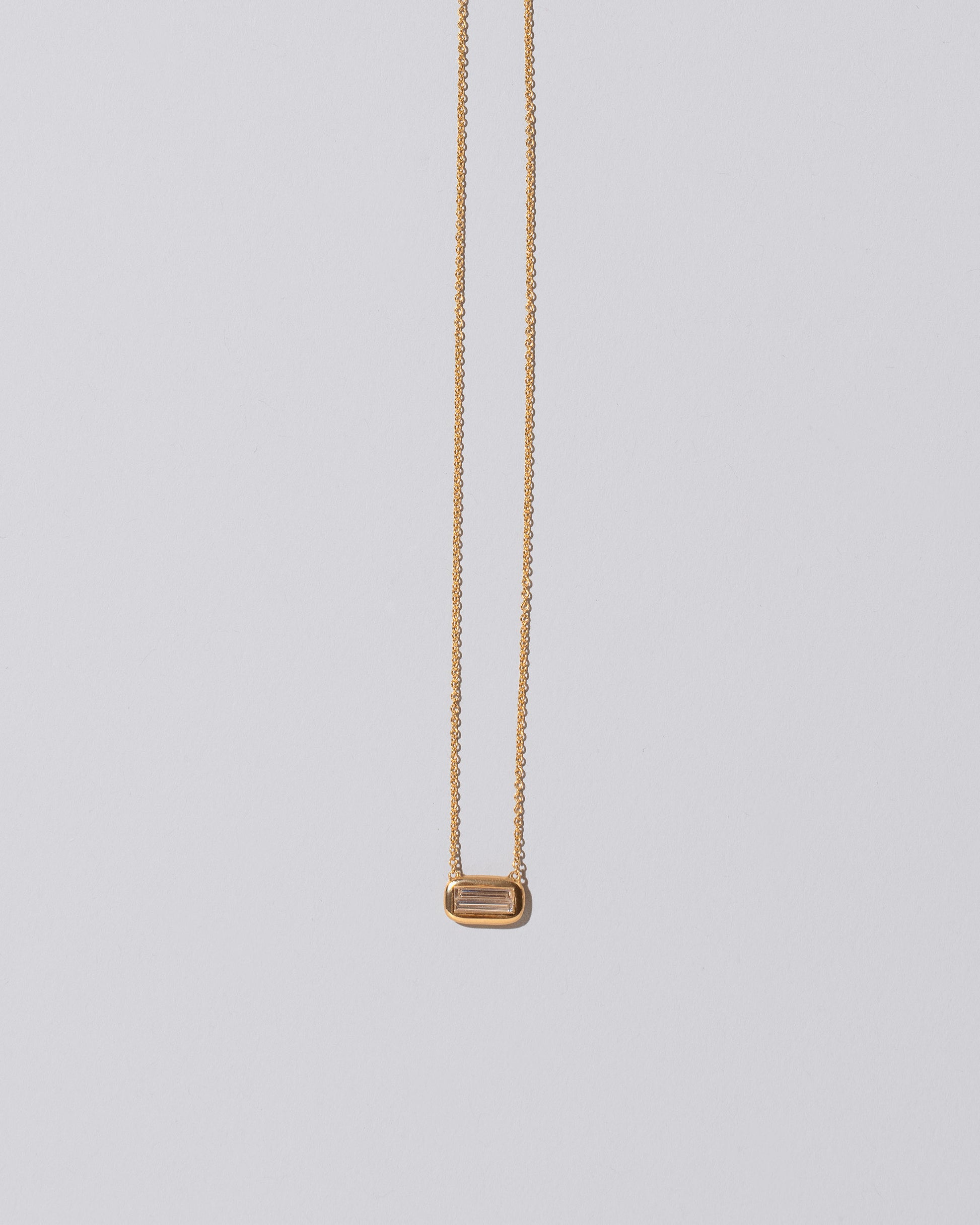 Shah Necklace on light color background.