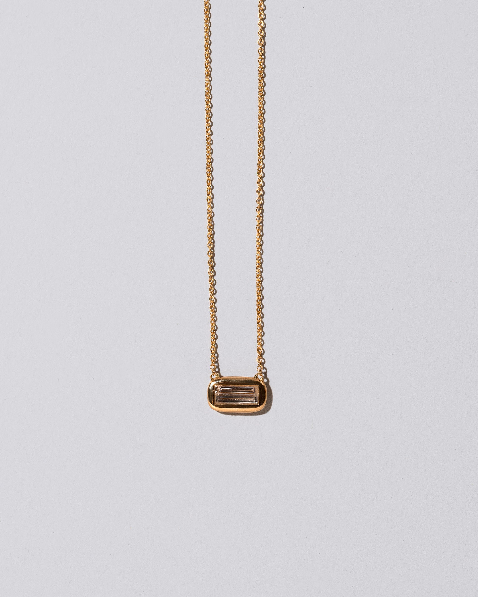 Closeup details of the Shah Necklace on light color background.