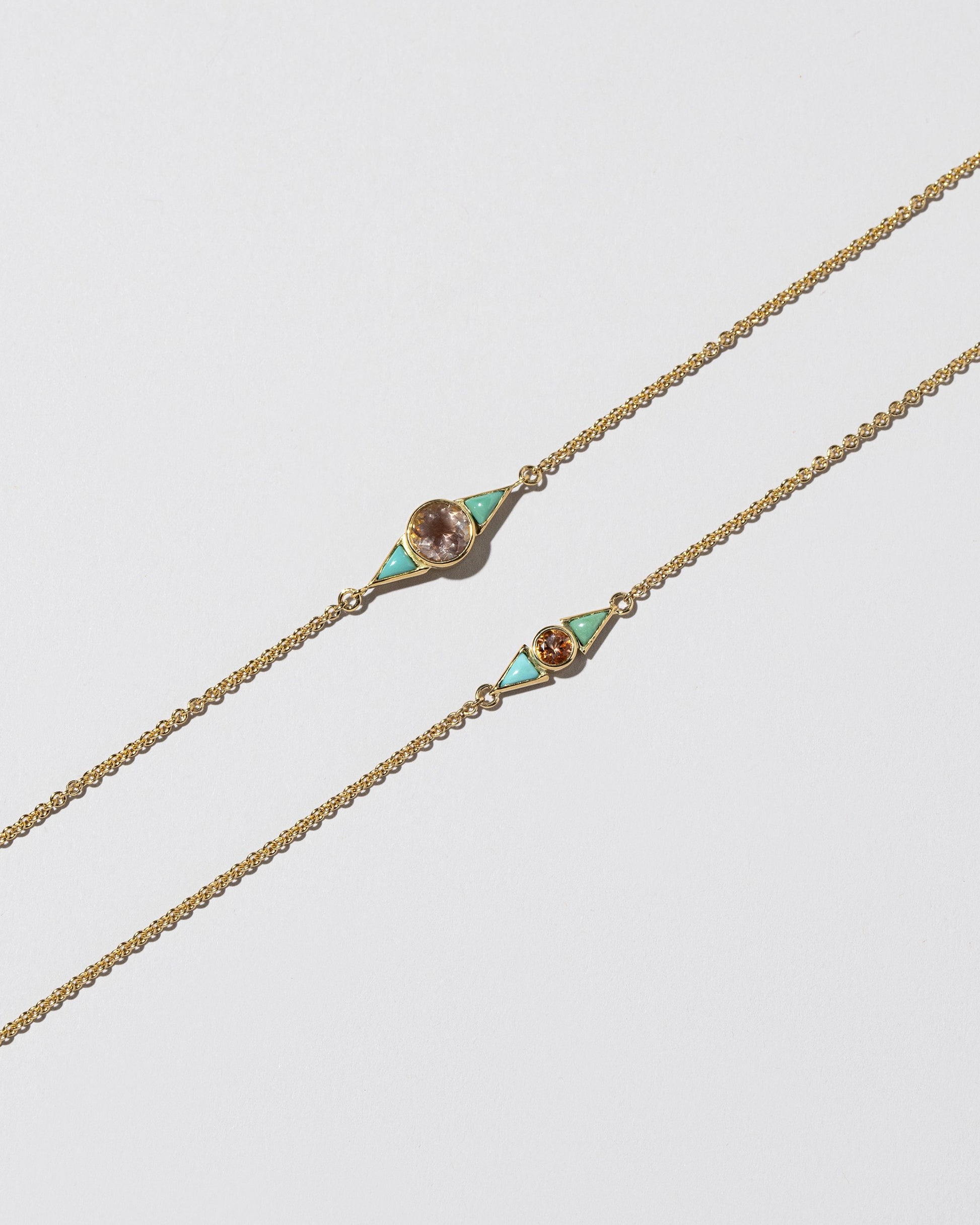 Closeup details of the Sunstone & Turquoise Eye Bracelets on light color background.