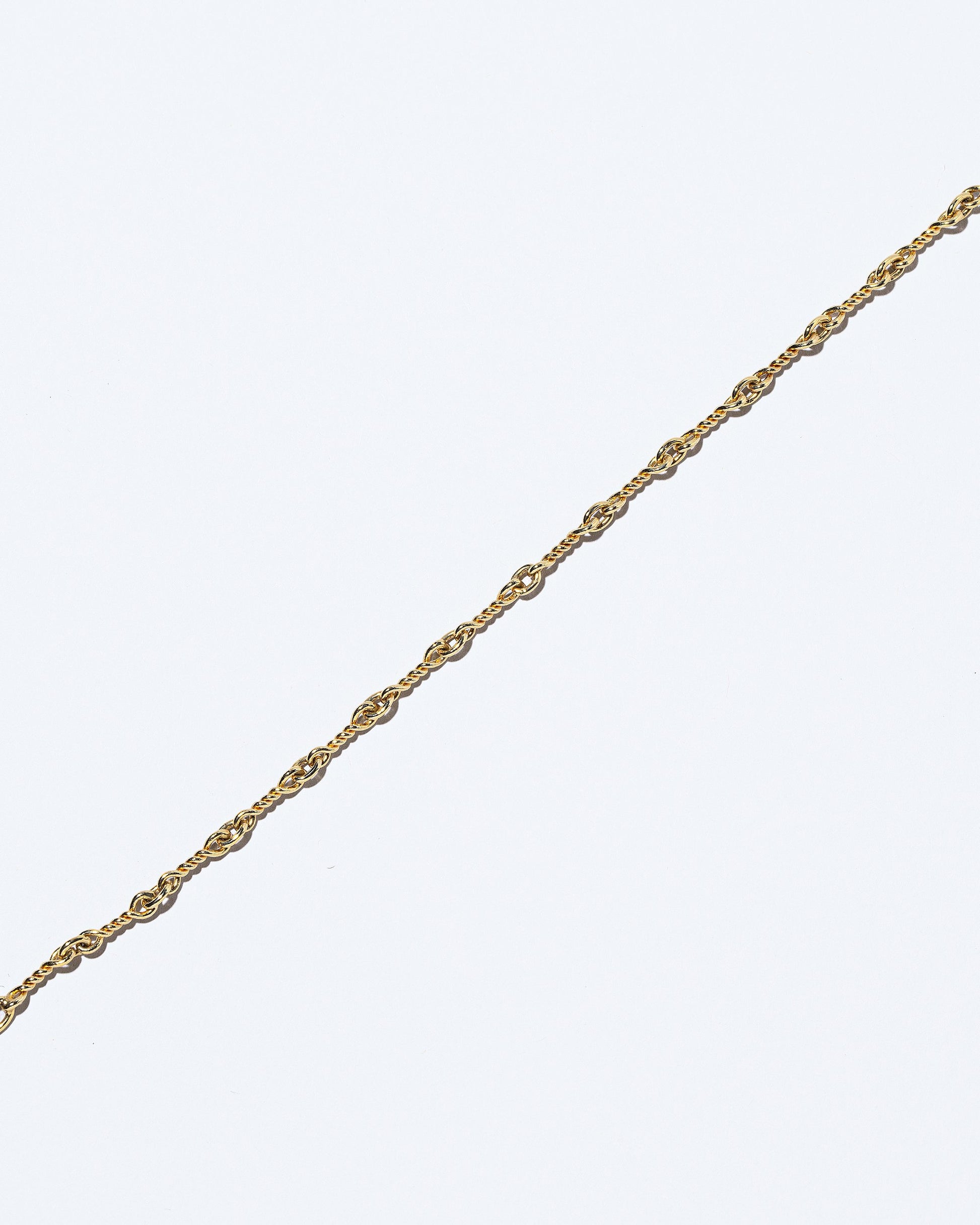 Closeup details of the Twisted Chain Bracelet on light color background.