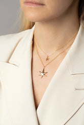 Styled image of model wearing the Verve Six Point Star Charms.
