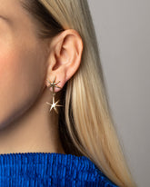 Styled image of model wearing the Verve Star Drop Earrings.