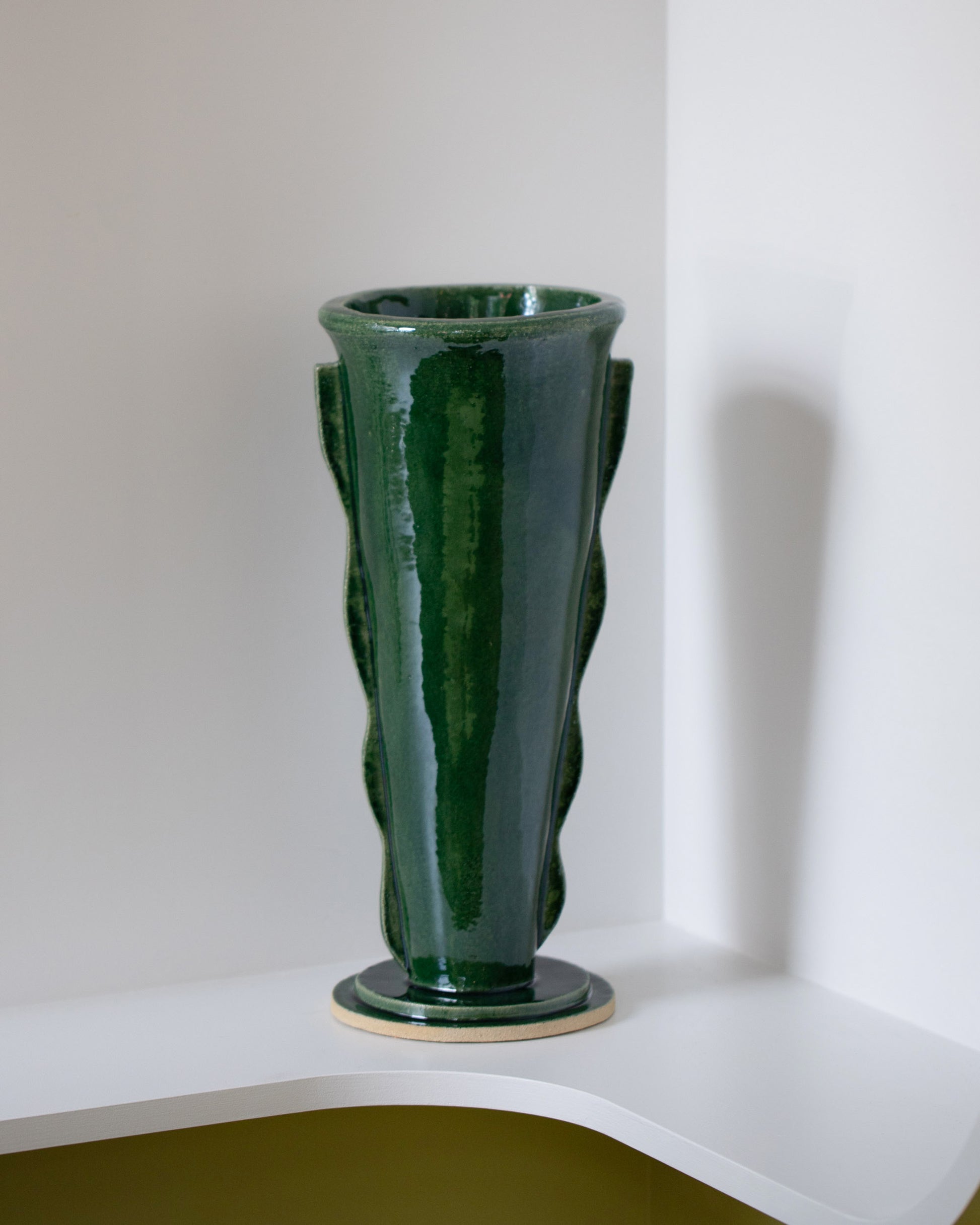 Morgan Peck Glassy Green Scallop Vase on light color background.
