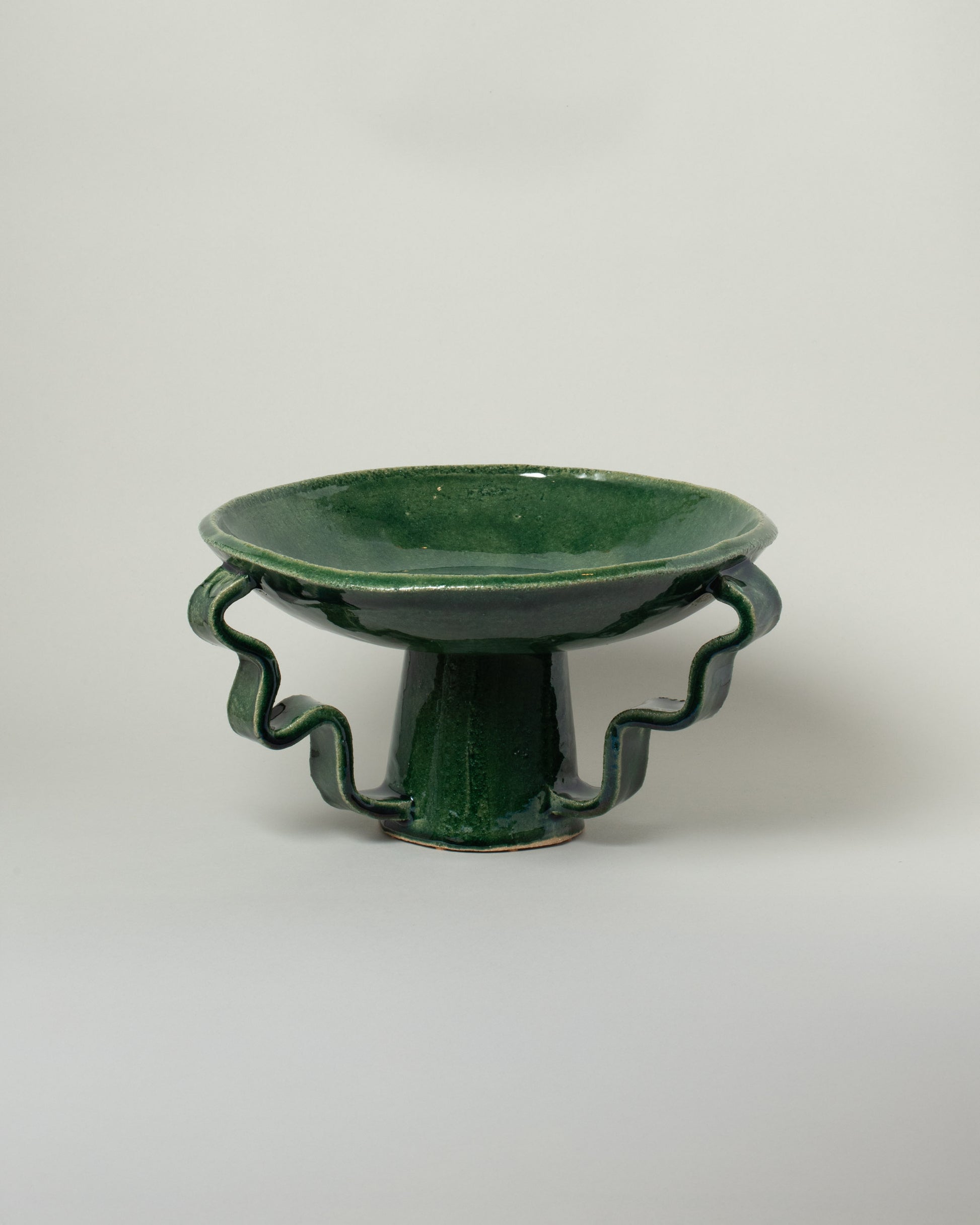 Morgan Peck Glassy Green Stretch Bowl on light color background.