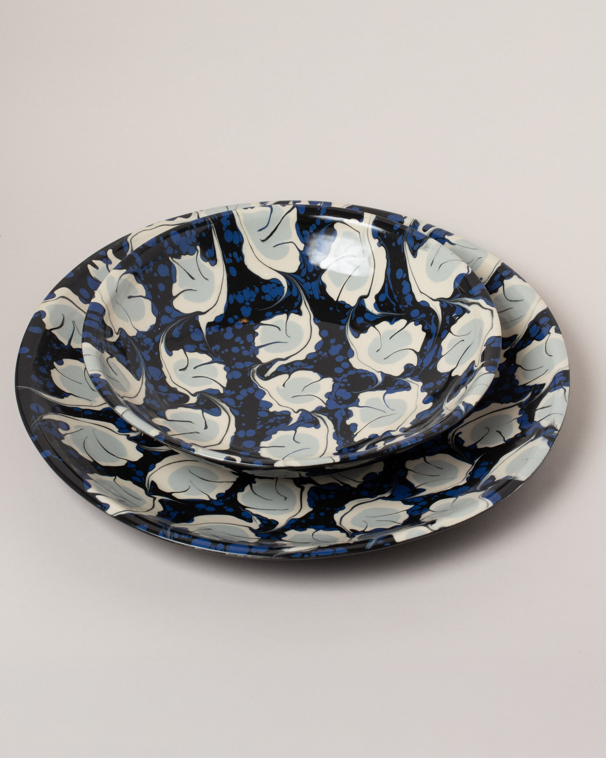 Closeup details of the Morgan Levine Midnight Pasta Bowl and Morgan Levine Midnight Platter on light color background.