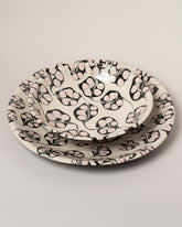 Closeup details of the Morgan Levine Berry Pasta Bowl and Morgan Levine Berry Platter on light color background.