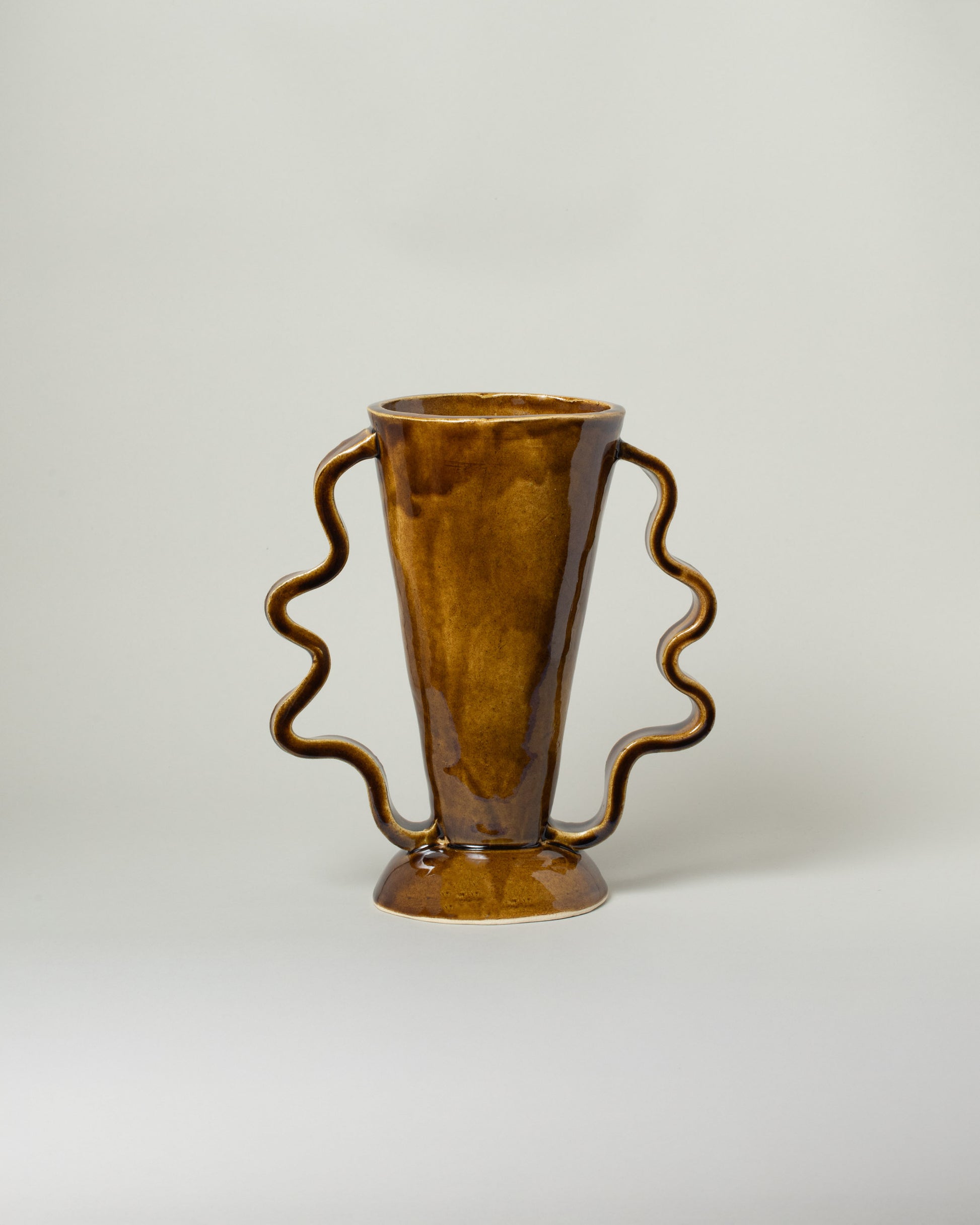Morgan Peck Stone Amber Stretch Vase on light color background.