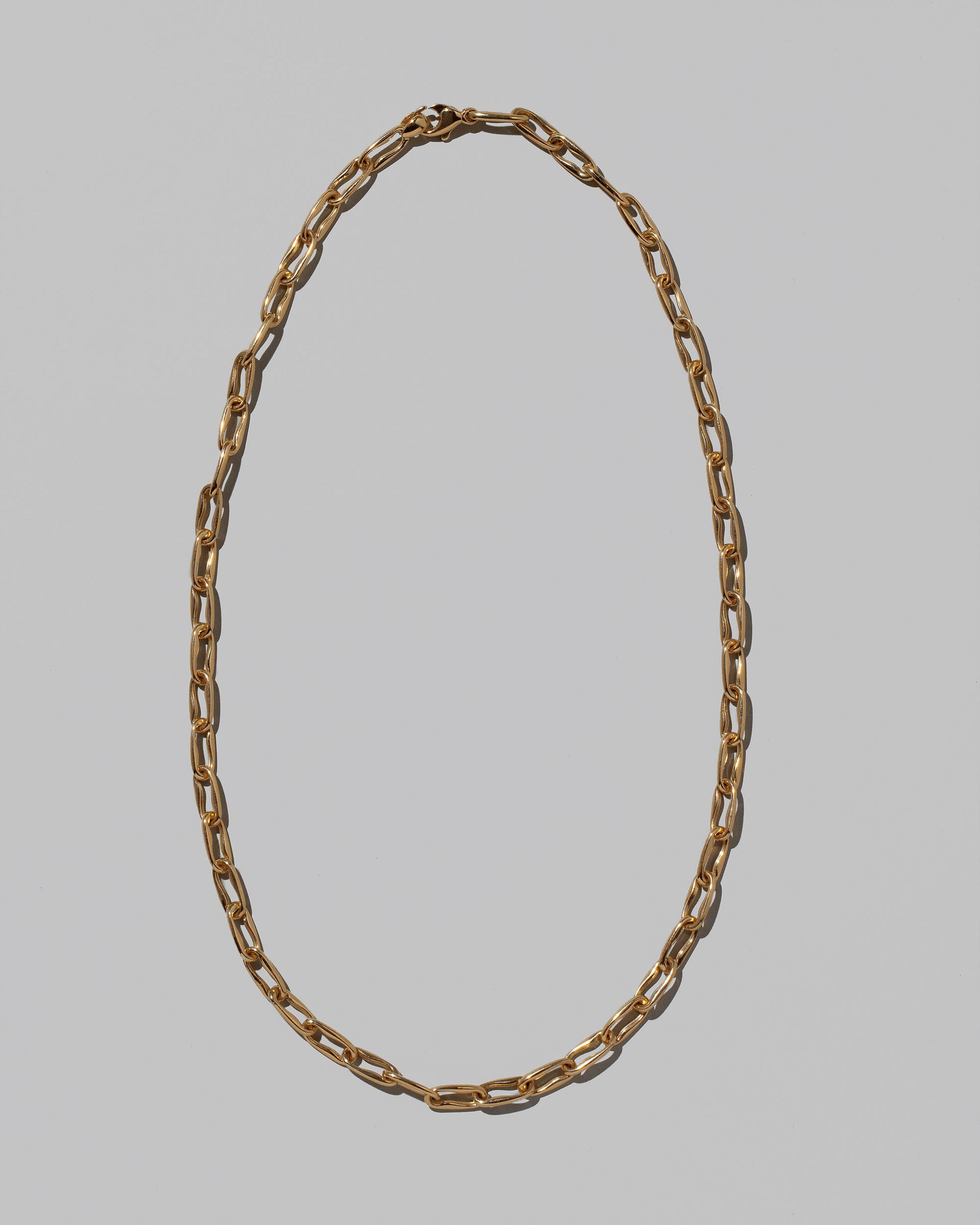 Wavy Link Chain Necklace on light color background.