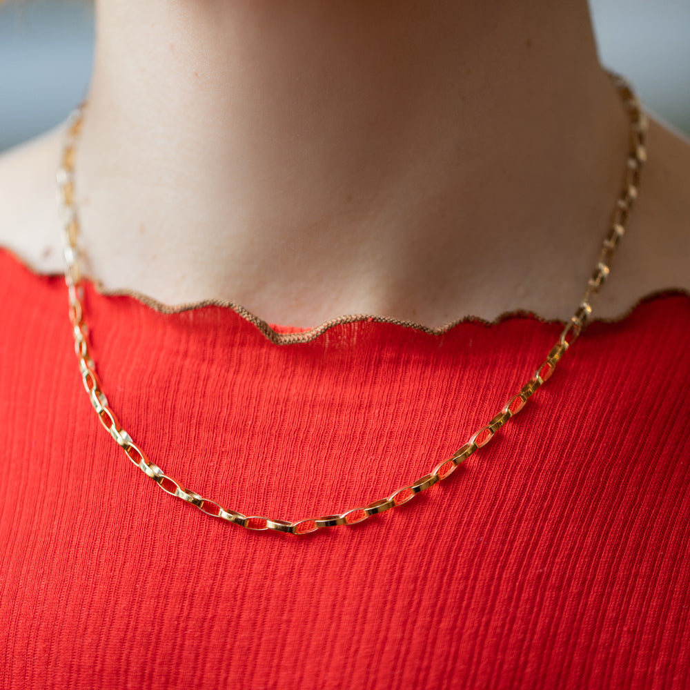 product_details::Flat Oval Link Chain Necklace on model.