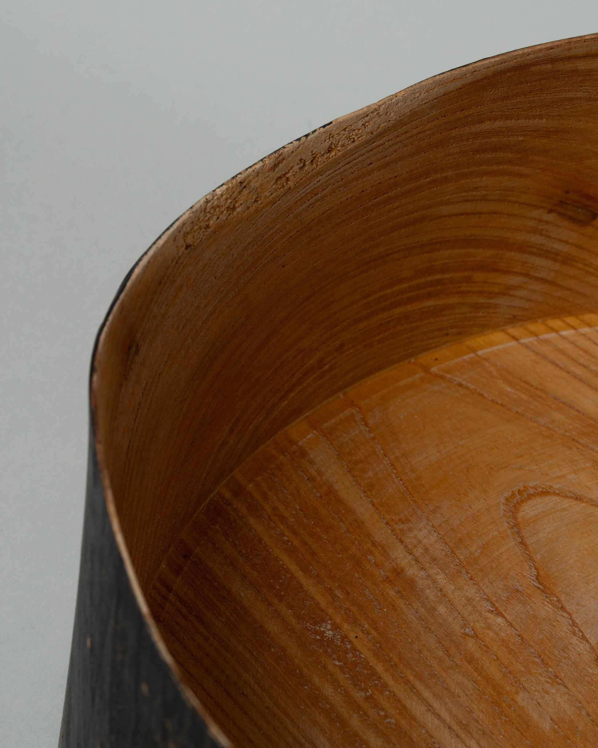 Closeup details of the Namu Home Goods Medium Zelkova Wood Black Lacquered Vessel on light color background.
