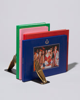 Detail view of the Carl Auböck Pair of Hands Brass Bookends Set on light color background.