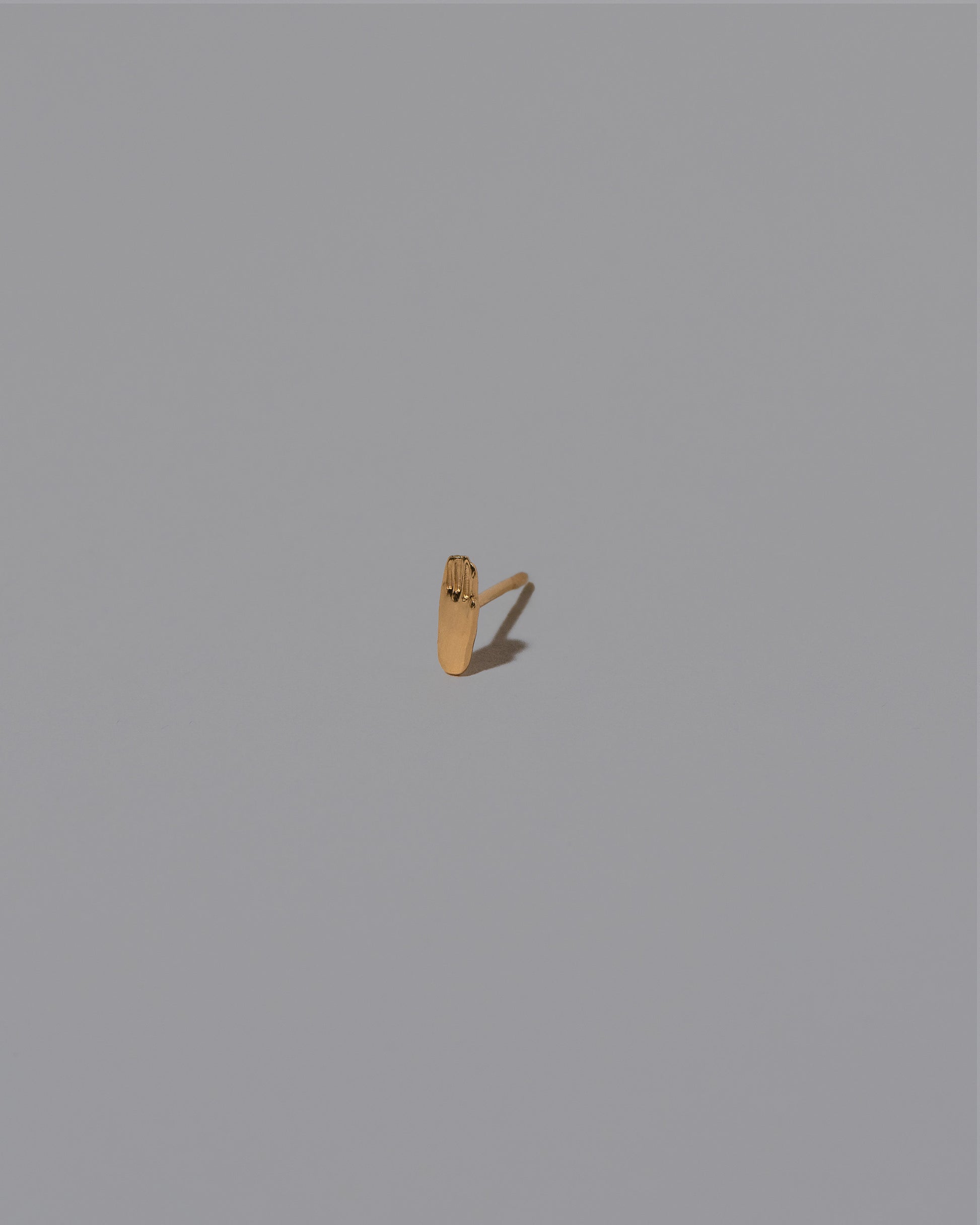 Hand Stud Earring Single on light color background.
