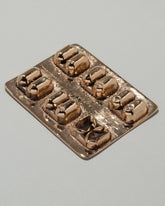 Pearce Objects Cast Bronze Cold Medicine on light color background.