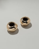 Pearce Objects Cast Bronze Globular Candle Holder Set on light color background.