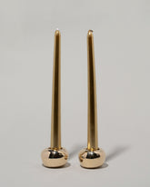 Pearce Objects Cast Bronze Globular Candle Holder Set with candles on light color background.