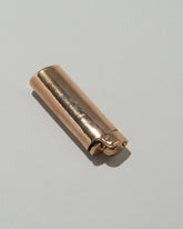 Closeup details of the Pearce Objects Cast Bronze Lighter on light color background.
