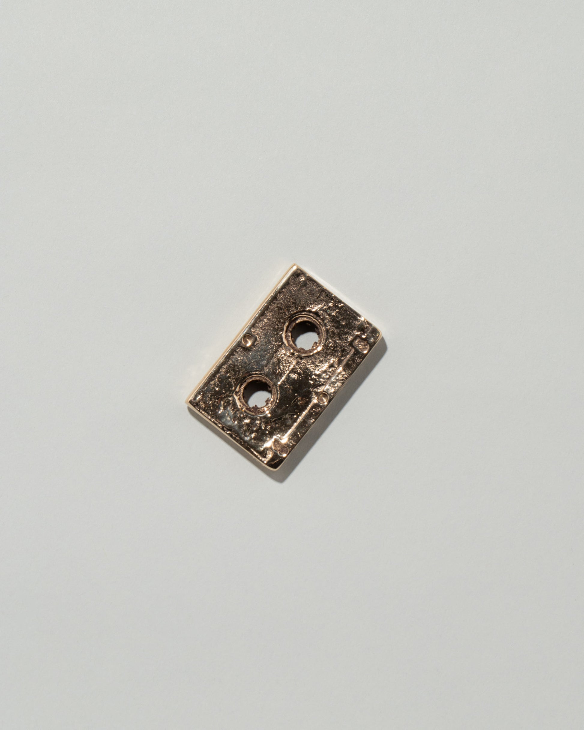 Pearce Objects Cast Bronze Mini Cassette Tape on light color background.