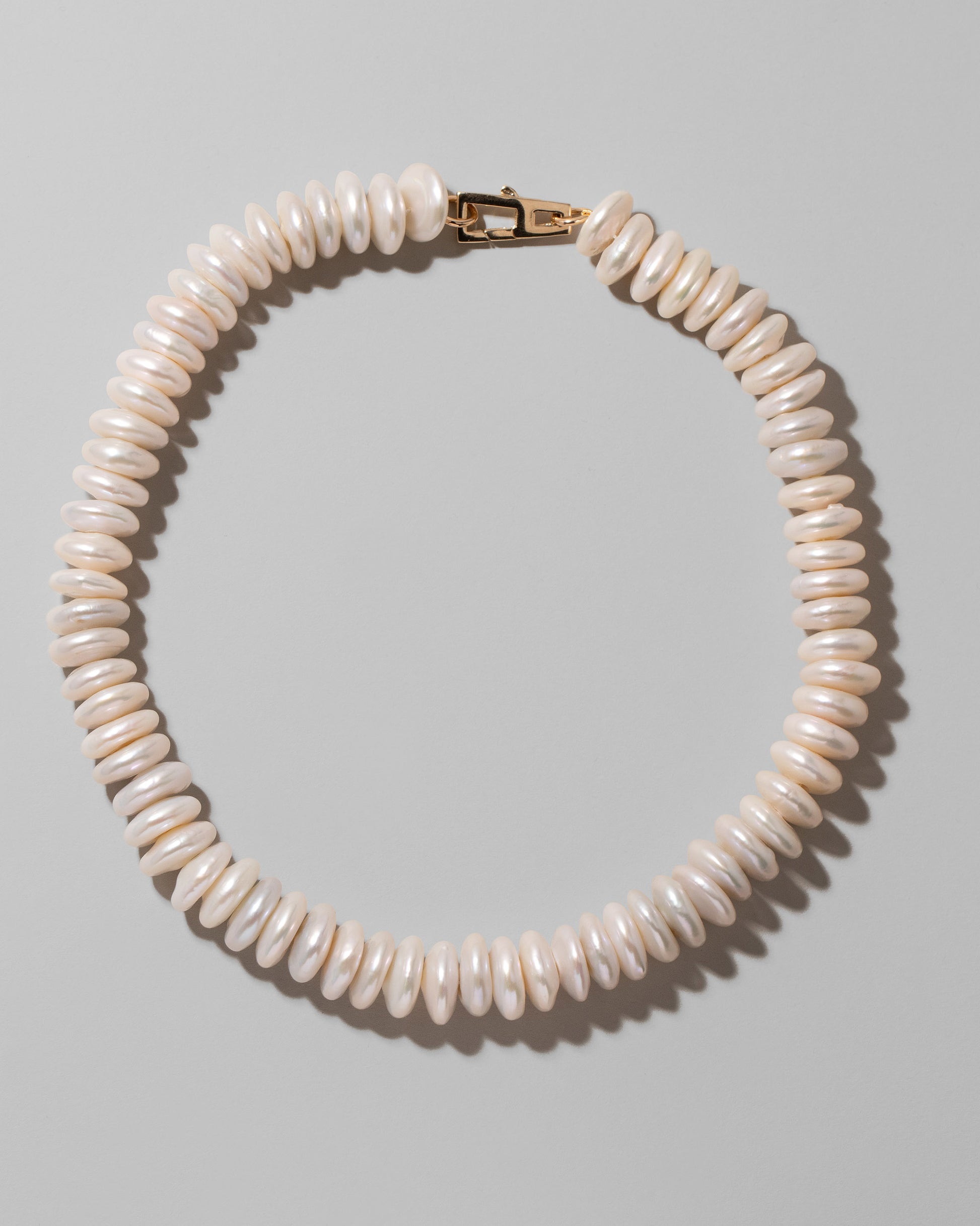 Button Pearl Choker Necklace on light color background.