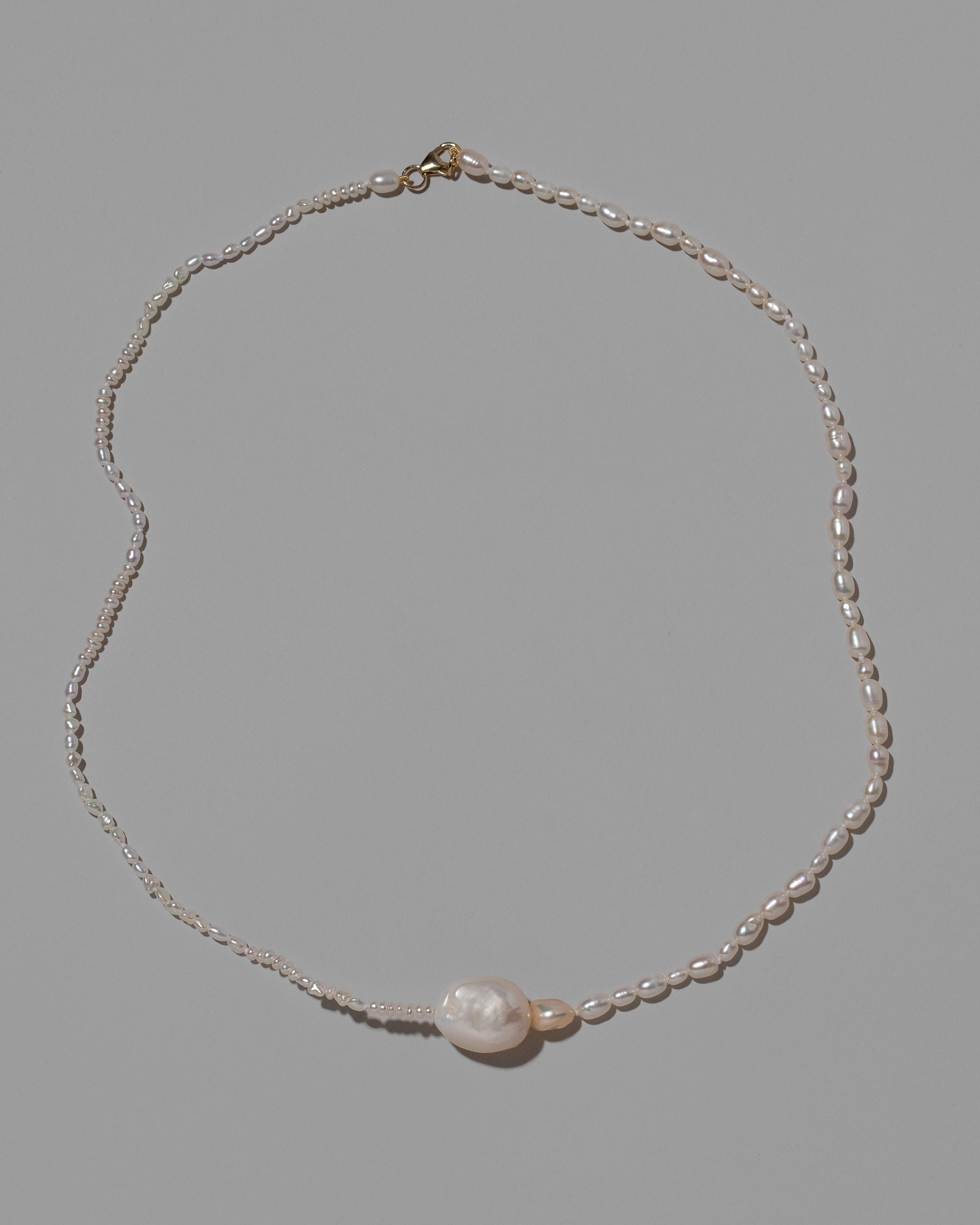 Pontus Pearl Necklace on light color background.