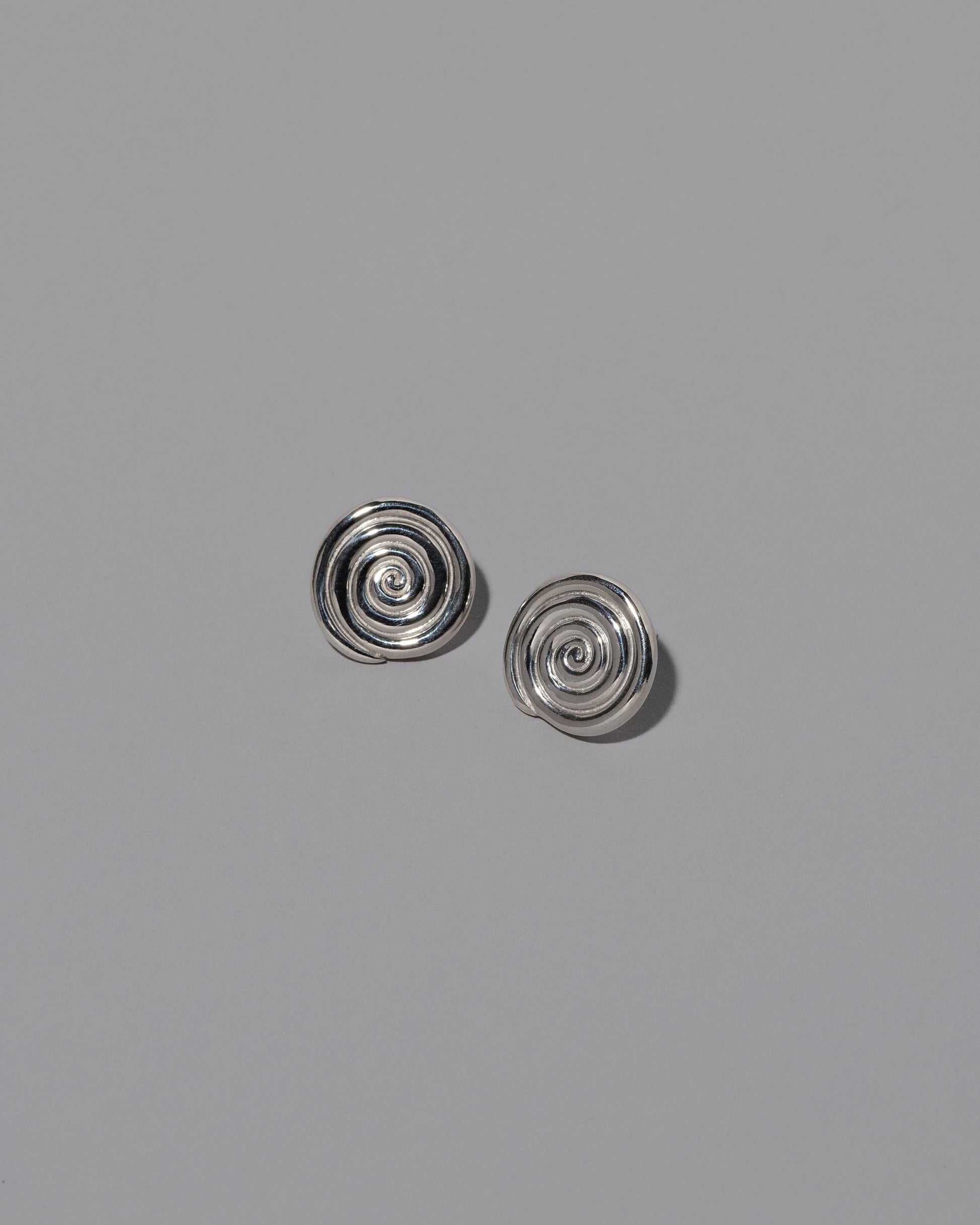 CRZM Sterling Silver Serpentinite Stud Earrings on light color background.