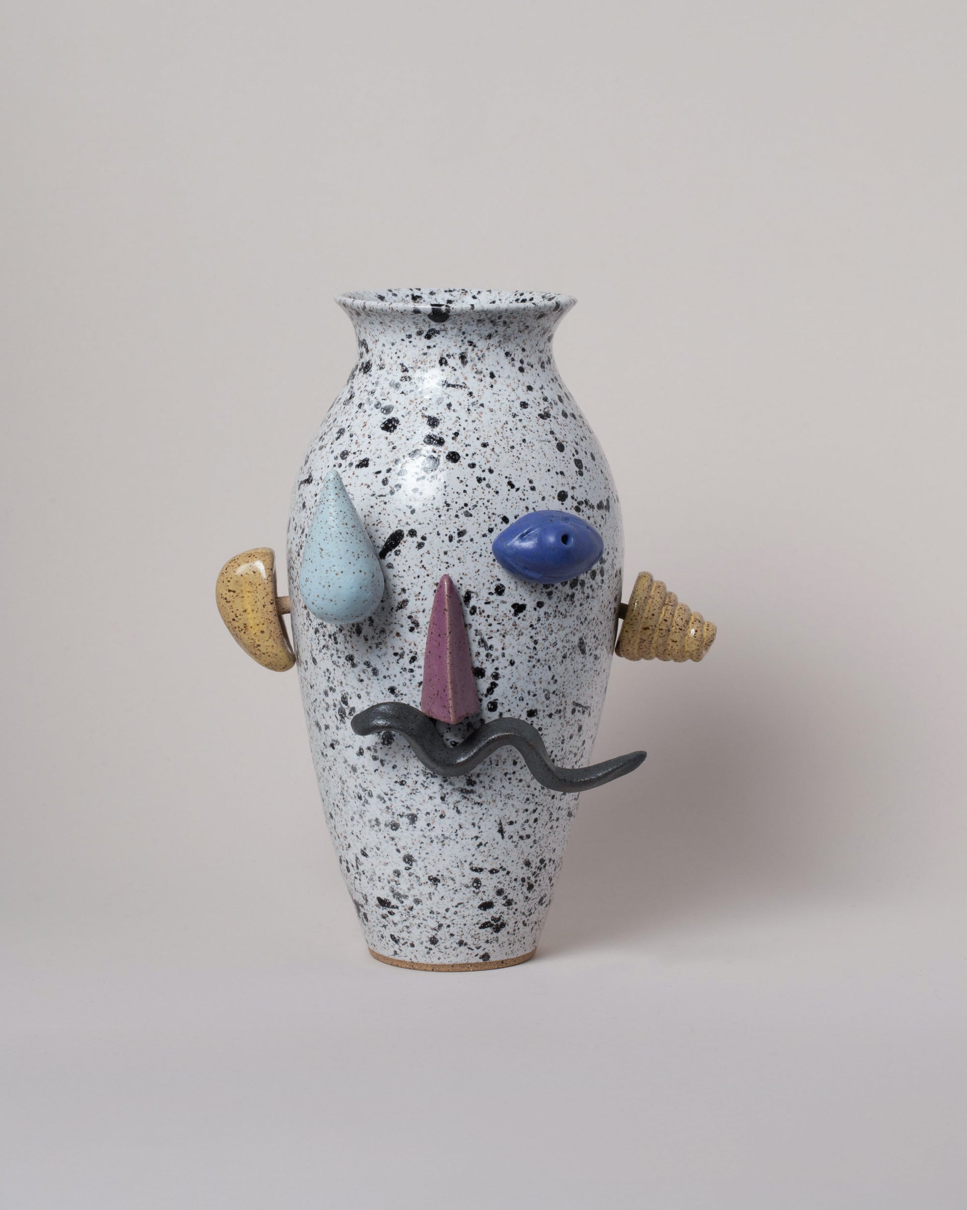 Recreation Center Apotropaia Efface Face Vase on light color background.