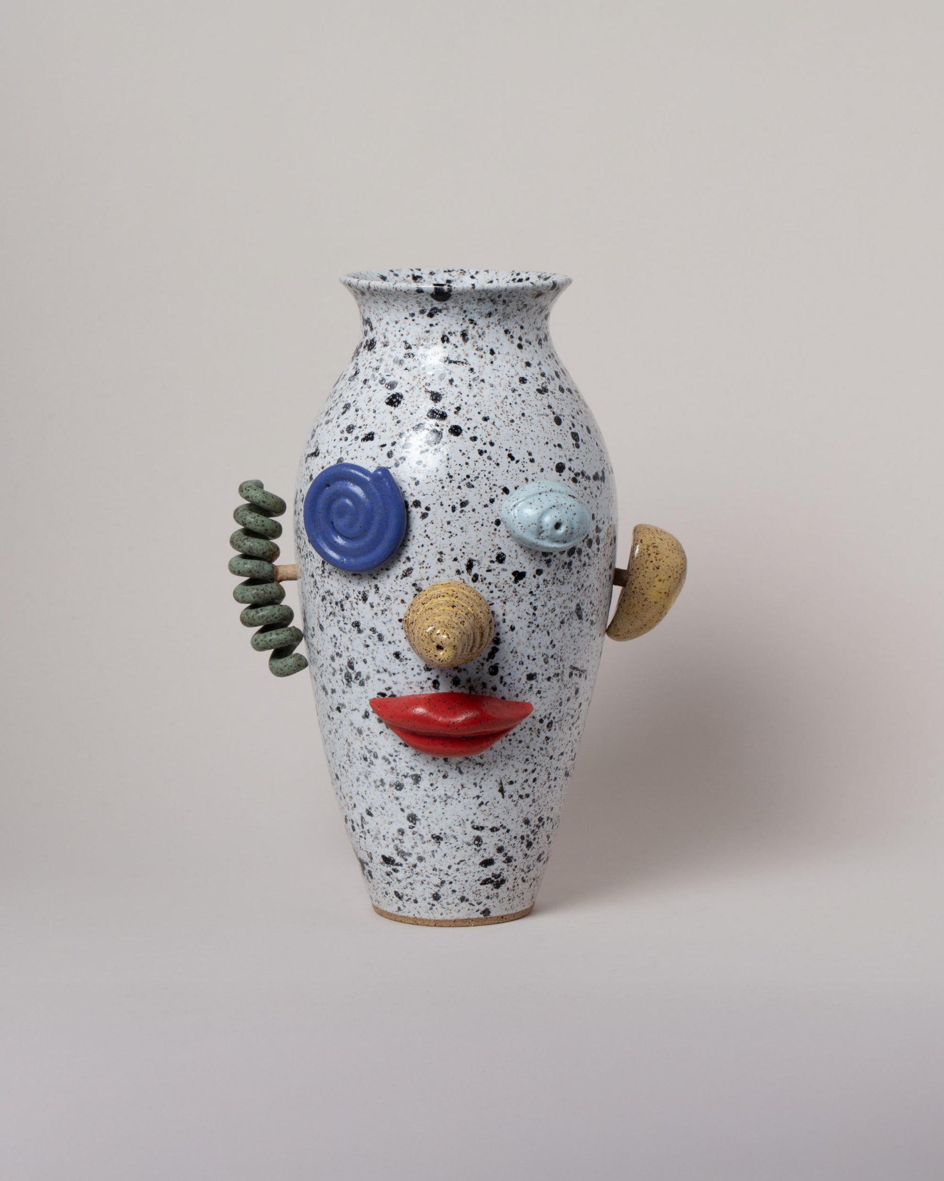 Recreation Center Apotropaia Efface Face Vase on light color background.