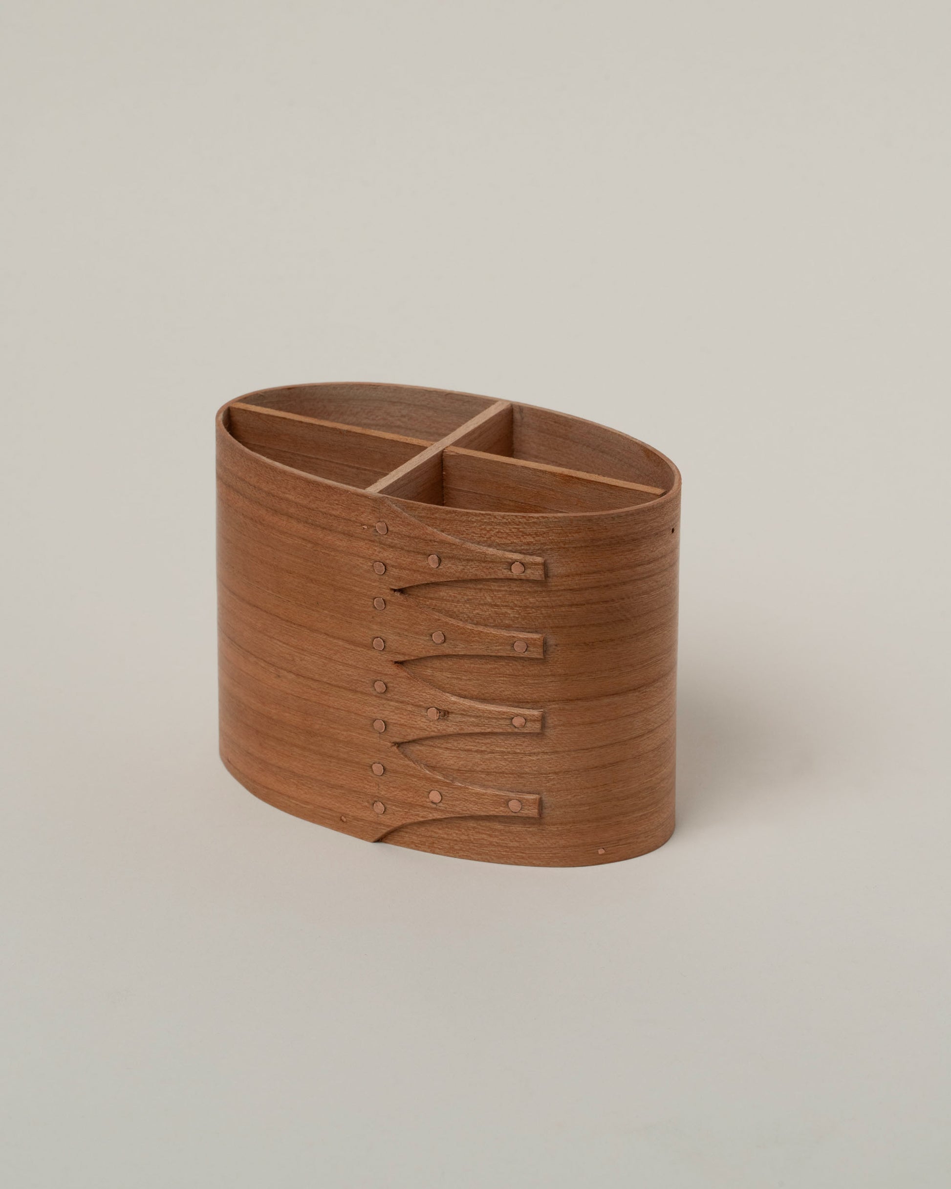 Closeup details of the Rikke Falkow Cherry Wood Pen Pot on light color background.