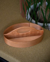 Styled image featuring the Rikke Falkow Cherry Wood Two-Sided Carrier.