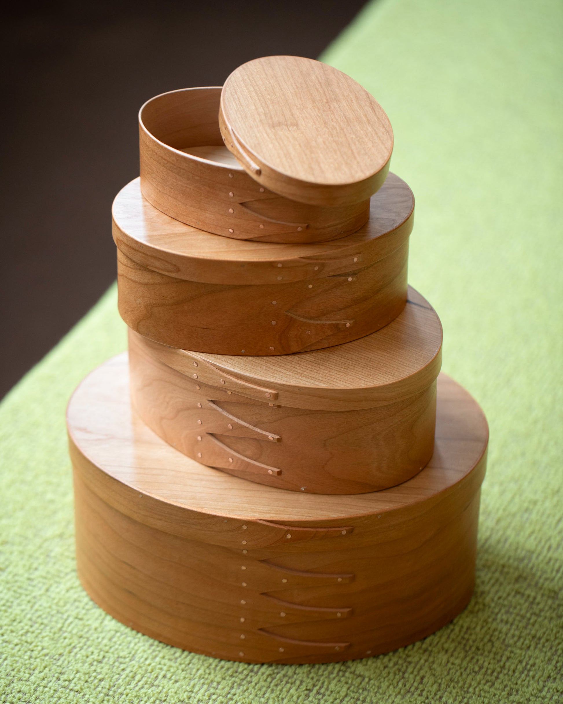 Styled image featuring the Rikke Falkow Cherry Wood Oval Boxes.