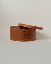 Detail view of the Rikke Falkow Extra Large Cherry Wood Oval Box on light color background.