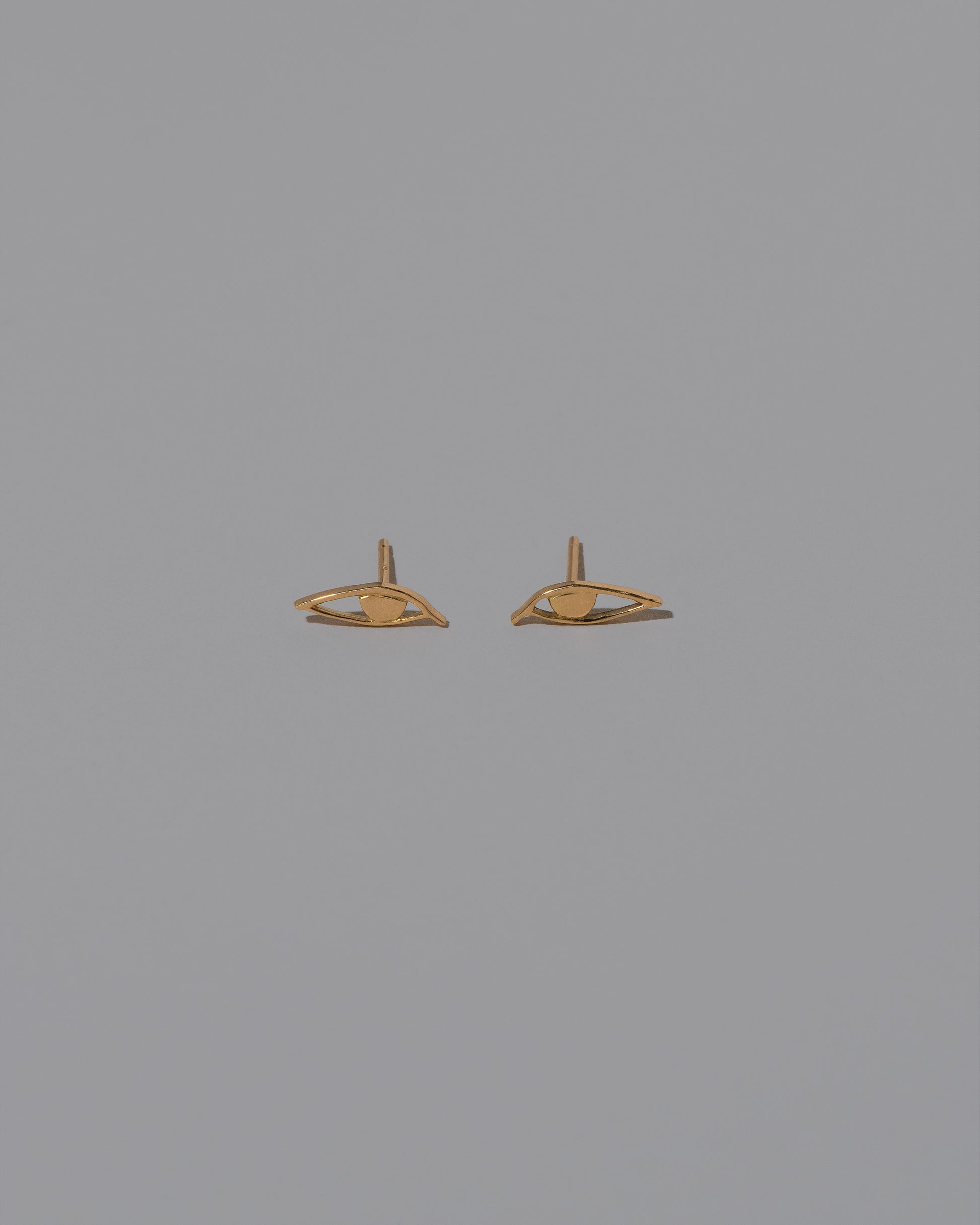 Left Eye Stud Earring Single and Right Eye Stud Earring Single on light color background.
